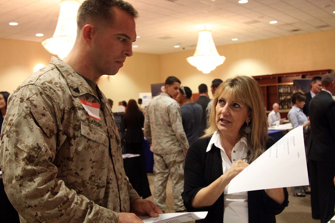 Terry Coulson speaks to Josh Lasure about available careers during the Hiring our Heroes job fair held at the Pacific Views Event Center here Sept. 19. The event was open to active duty, veterans, guard, reserve, and family members. Coulson is a human resources business partner at Granite construction.