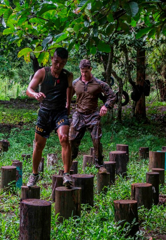 U.S. and Philippine Marines run through a jungle obstacle course during Amphibious Landing Exercise 2014 (PHIBLEX 14) at Marine Barracks Gregorio Lim, Ternate, Cavite, Republic of the Philippines, Sept. 18, 2013. PHIBLEX is a bilateral training exercise that demonstrates the commitment of the United States and Republic of the Philippines to mutual security and their long-term partnership. It also ensures the readiness of a bilateral force to rapidly respond to regional humanitarian crises. The U.S. Marines are with Force Reconnaissance Platoon, Maritime Raid Force, 13th Marine Expeditionary Unit. The Philippine Marines are with Force Reconnaissance Battalion. (U.S. Marine Corps photo by Sgt. Ammon W. Carter, 13th Marine Expeditionary Unit Combat Camera/Released)