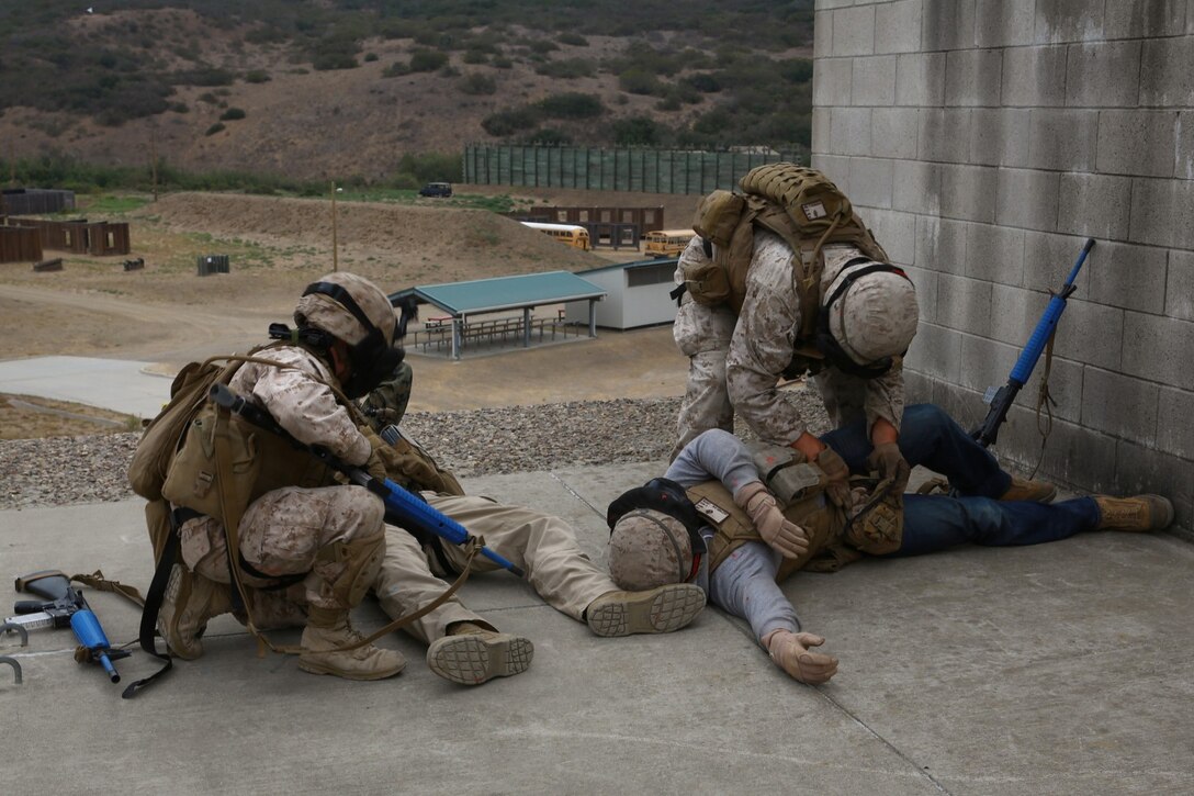 Marines with Delta Company, 1st Battalion, 1st Marine Regiment, search role-players acting as killed enemy combatants during an Urban Leaders Course training scenario at a military operations on urban terrain facility here, Sept. 19, 2013. The Marines provided around-the-clock security for a building at the facility and then assaulted a nearby building with armed role-players, played by fellow Marines, who were threatening overall security. The enemy combatants also serve with the battalion. The Marines, both friendly and enemy forces, used simunition rounds - simulated ammunition that contains paint to mark upon impact. Delta Co. focused on laws of land warfare, urban warfare and counterinsurgency tactics during the training.