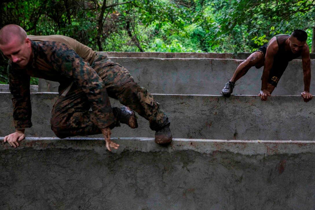 U.S. and Philippine Marines run through a jungle obstacle course during Amphibious Landing Exercise 2014 (PHIBLEX 14) at Marine Barracks Gregorio Lim, Ternate, Cavite, Republic of the Philippines, Sept. 18, 2013. PHIBLEX is a bilateral training exercise that demonstrates the commitment of the United States and Republic of the Philippines to mutual security and their long-term partnership. It also ensures the readiness of a bilateral force to rapidly respond to regional humanitarian crises. The U.S. Marines are with Force Reconnaissance Platoon, Maritime Raid Force, 13th Marine Expeditionary Unit. The Philippine Marines are with Force Reconnaissance Battalion. (U.S. Marine Corps photo by Sgt. Ammon W. Carter, 13th Marine Expeditionary Unit Combat Camera/Released)