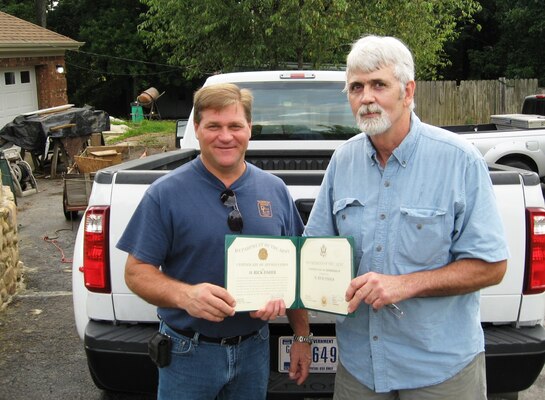 Carl Scott, left, lock & dam equipment supervisor at Tennessee River Operations Center, Florence, Ala., presents retiree Rick Fisher replacement  Certificates of Retirement and Appreciation June 18, 2013 in Chattanooga. Fisher, a 30-year retiree from U.S. Army Corps of Engineers Nashville District, lost everything in a 2010 house fire. “Getting the replacement certificates was a real shot-in-the-arm to me and I am extremely grateful to Carl and everyone who made it possible.  After losing my home and all its contents, I learned that money is not everything. Having this Retirement Certificate helps validate 30 years of my life,” Fisher added.