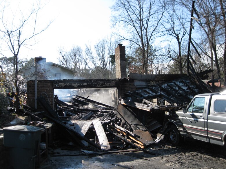 Smoke rises from a hotspot in all that remains after a Jan. 9, 2010 fire that completely destroyed the Chattanooga home of U.S. Army Corps of Engineers Nashville District retiree Rick Fisher.