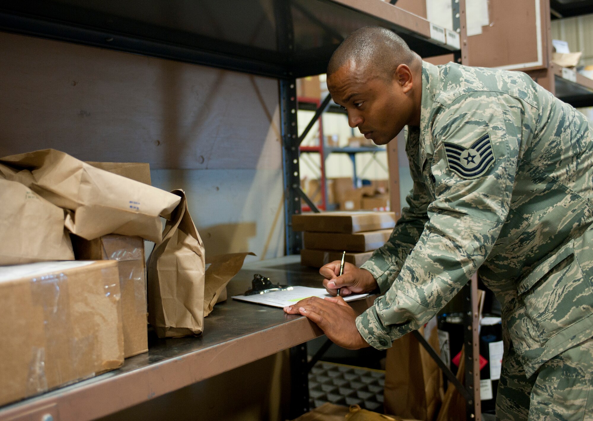 Tech Sgt. Curtis Kelley, 99th Logistic Readiness Squadron documented cargo specialist, logs incoming items at the documented cargo section Sept. 18, 2013, at Nellis Air Force Base, Nev. Kelly was named   Nellis AFB’s First Sergeant Association’s Diamond Sharp Award for August. During the month, he led a 30 man LRS team in helping repair a local 142-room Veterans Village facility. He also organized a squadron school supply drive, which helped collect more than $708 worth of supplies, for 603 underprivileged children in the local area. (U.S. Air Force photo by Staff Sgt. Michael Charles)