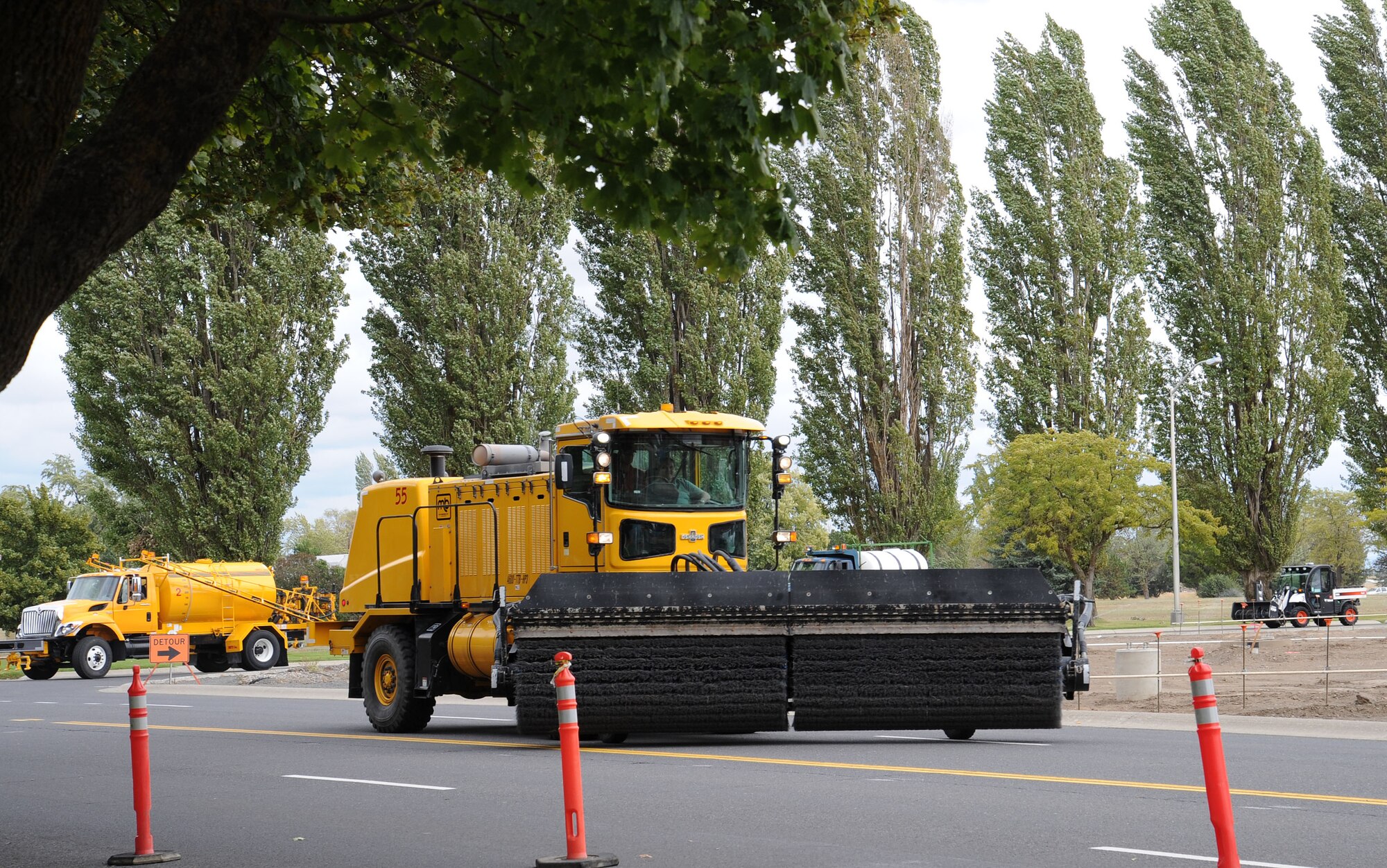 Snow removal vehicles pass by the Headquarters Building during the annual snow parade at Fairchild Air Force Base, Wash., Sept. 23, 2013. The snow parade is an annual event that symbolizes the formal beginning of the snow removal season. (U.S. Air Force photo by Airman 1st Class Janelle Patiño/Released)