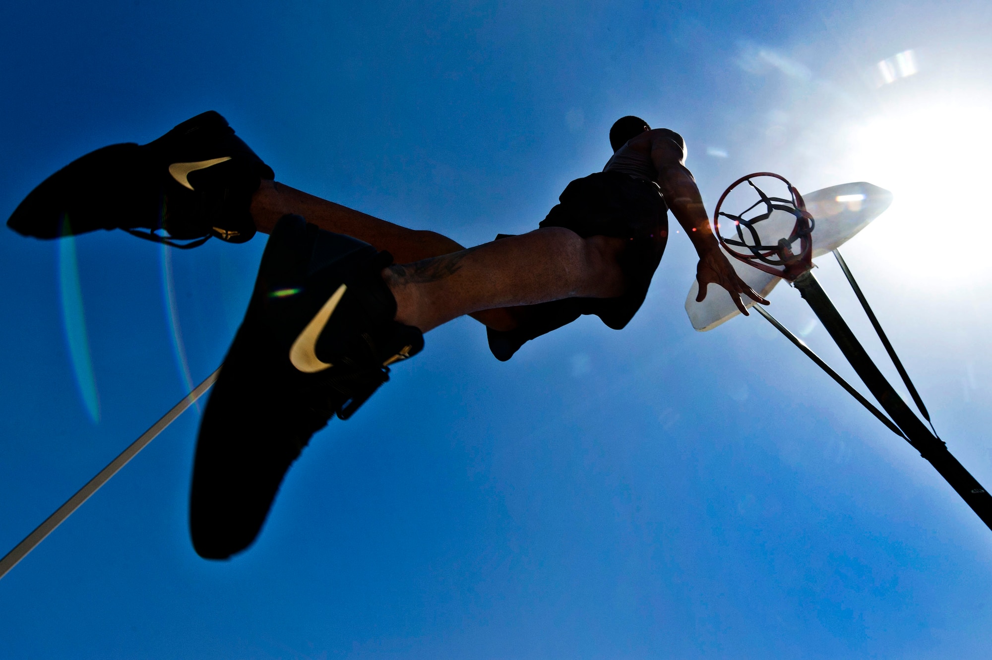 U.S. Air Force Senior Airman Nathaniel Mills, 99th Security Forces Squadron patrolman, jumps to dunk a basketball Sept. 18, 2013, at a basketball court in Las Vegas. Mills was recognized at a U.S.A. Basketball team scrimmage July, 25, where he performed a dunk that became a Top Play on ESPN’s Sports Center. (U.S. Air Force photo by Senior Airman Daniel Hughes)