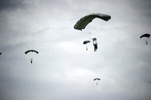 Honduran Special Forces Operators from the 15th Fuerzas Especiales Battalion and Green Berets from 7th Special Forces Group (Airborne) maneuver under canopy after exiting a AC130 Soto Cano Air Base, Honduras., Sept. 21, 2013. Green Berets from 7SFG(A) and Honduran special operations troops conducted a high altitude low opening parachute jump. Sixteen jumpers exited the ramp of a AC130 at the altitude of 16,000 ft . (U.S. Army photo by Spc. Steven K. Young/Released)
