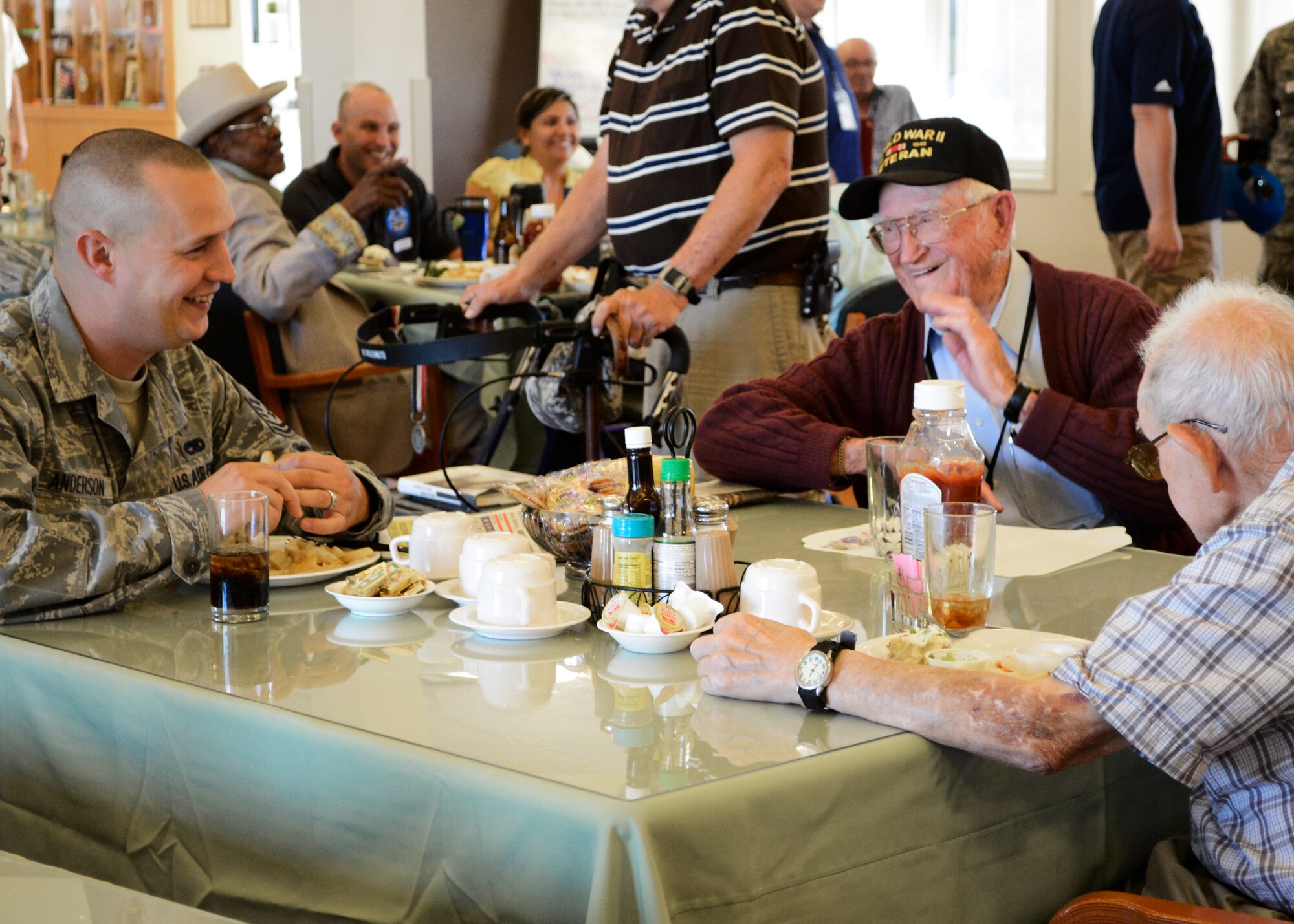 Tech. Sgt. Brody Anderson (left), 412th command chief executive assistant, visits with residents during the 66th Air Force birthday barbeque celebration at the Lancaster Veterans Home of California Sept. 18. (U.S. Air Force photo by Rebecca Amber)

