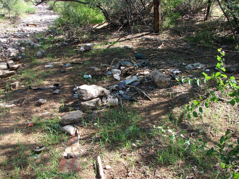 An abandoned camp and a pile of trash are evidence of the illegal activities, such as smuggling, occuring throughout the Arizona-Mexico borderlands, including at the Barry M. Goldwater Range-East. 56 RMO/ESM collects and removes this type of trash from the Range.   Photo: A. Lobo