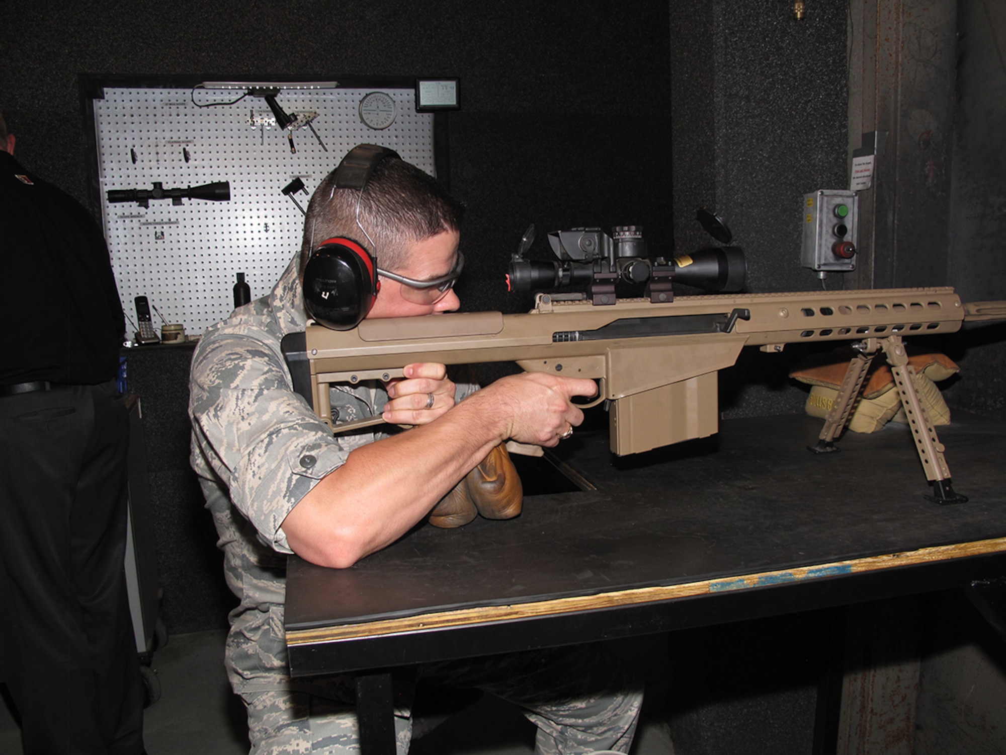 AEDC Commander Col. Raymond Toth fires the Barrett M107A1 .50 caliber military rifle at the Barrett Firearms Manufacturing Inc. factory. (Photo by Claude Morse)