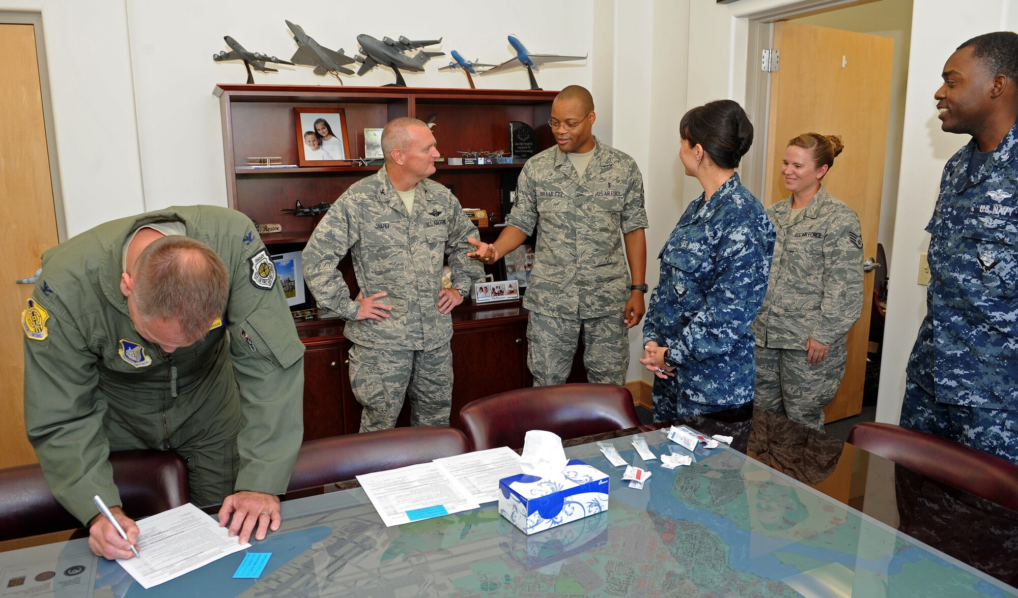 From left to right, Col. John Roscoe, 15th Wing commander, Col. Terry Scott, 15th Wing vice commander, Chief Master Sgt. Leslie Bramlett, 15th Wing command chief, U.S. Navy Hospital Corpsman 2nd Class Mishell Miyashiro, Navy Health Clinic Hawaii Preventive Medicine (NHCH), Staff Sgt. Aimee Braxton, 15th Medical Operations Squadron NCO in Charge of immunizations, and U.S. Navy Hospital Corpsman 2nd Class Miguel May NHCH, prepare to administer flu vaccinations to 15 WG senior leaders at 15th Wing headquarter building, Joint Base Pearl Harbor-Hickam, Hawaii, Sept. 4, 2013. Influenza is a serious disease that can lead to hospitalization and sometimes even death.  Influenza symptoms are headaches, dry coughs, fatigue and weakness, nasal congestion, and aching muscles. Every flu season is different, and influenza infection can affect people differently. (U.S. Air Force photo/Tech. Sgt. Jerome S. Tayborn) 