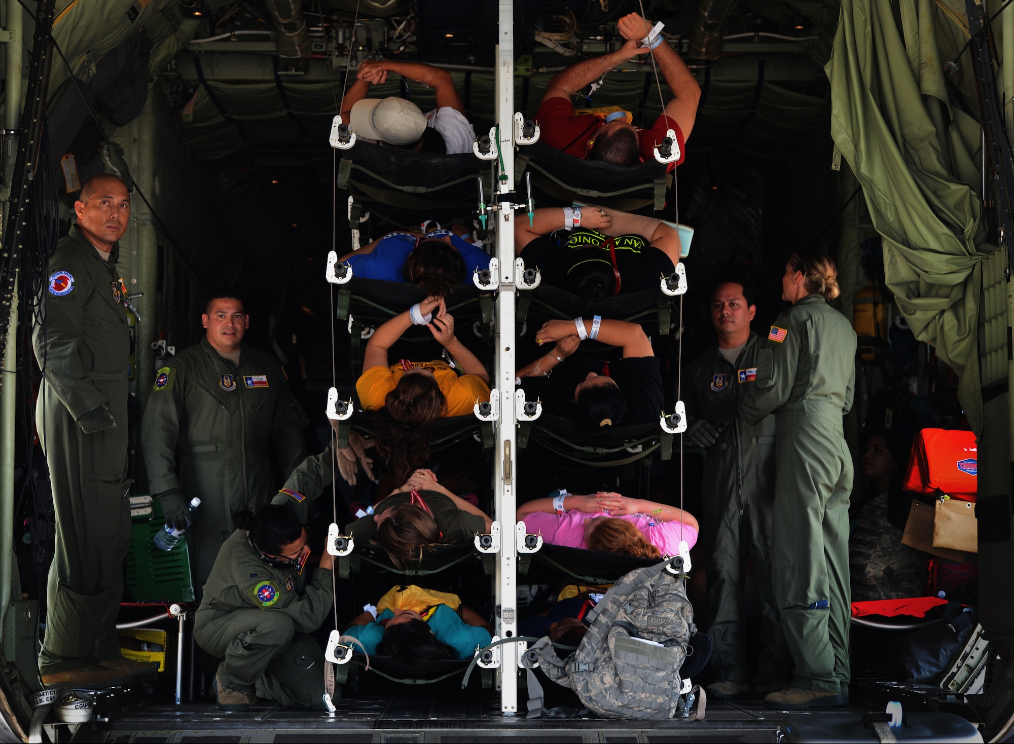 Patients lay on stacked litters onboard a WC-130J Hercules aircraft during a mass casualty exercise, Sept. 19 at Kelly Field Annex, Texas. Airmen from the 433rd Aeromedical Evaluation Squadron provided medical care to patients until they were off-loaded from the aircraft for triage. The patients were placed directly in an ambulance bus and taken to local hospitals, including the San Antonio Military Medical Center at Fort Sam Houston. (U.S. Air Force Photo/A1C Krystal Ardrey)