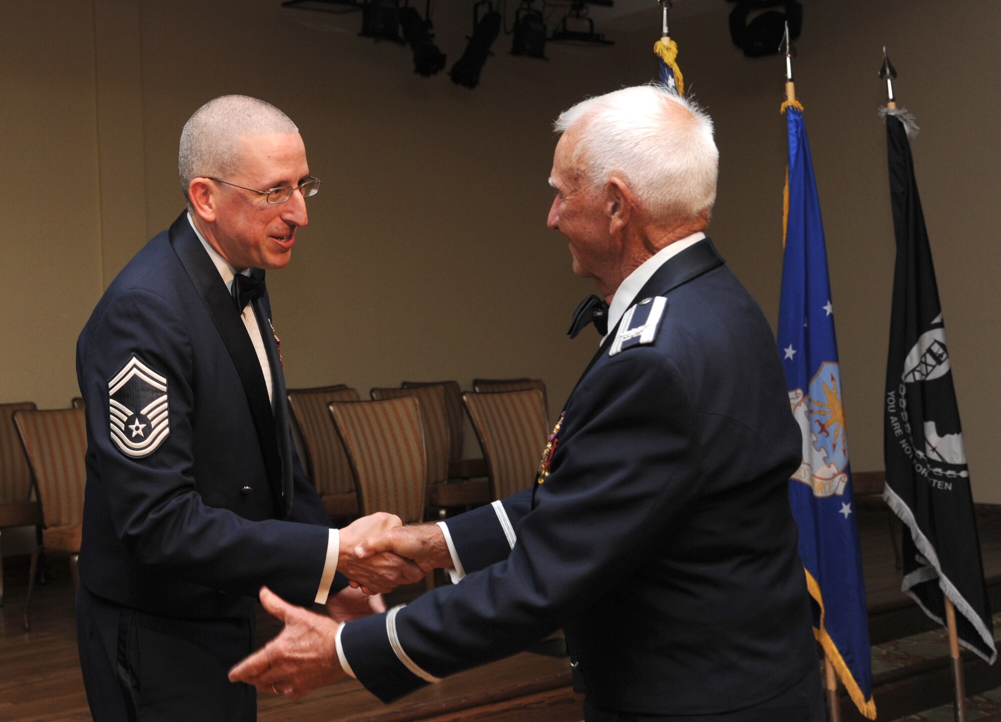 Senior Master Sgt. Michael Bullington, 336th Training Squadron and Air Force Association, John C. Stennis Chapter #332 president, welcomes Retired Col. Carlyle Harris, former prisoner of war, to the stage as the guest speaker for the Air Force’s 66th Birthday Ball on Sept. 21, 2013, at Keesler Air Force Base, Miss. The event, sponsored by the AFA, John C. Stennis Chapter #332, also celebrated the 81st Training Wing’s 20th anniversary.  (U.S. Air Force photo by Kemberly Groue)