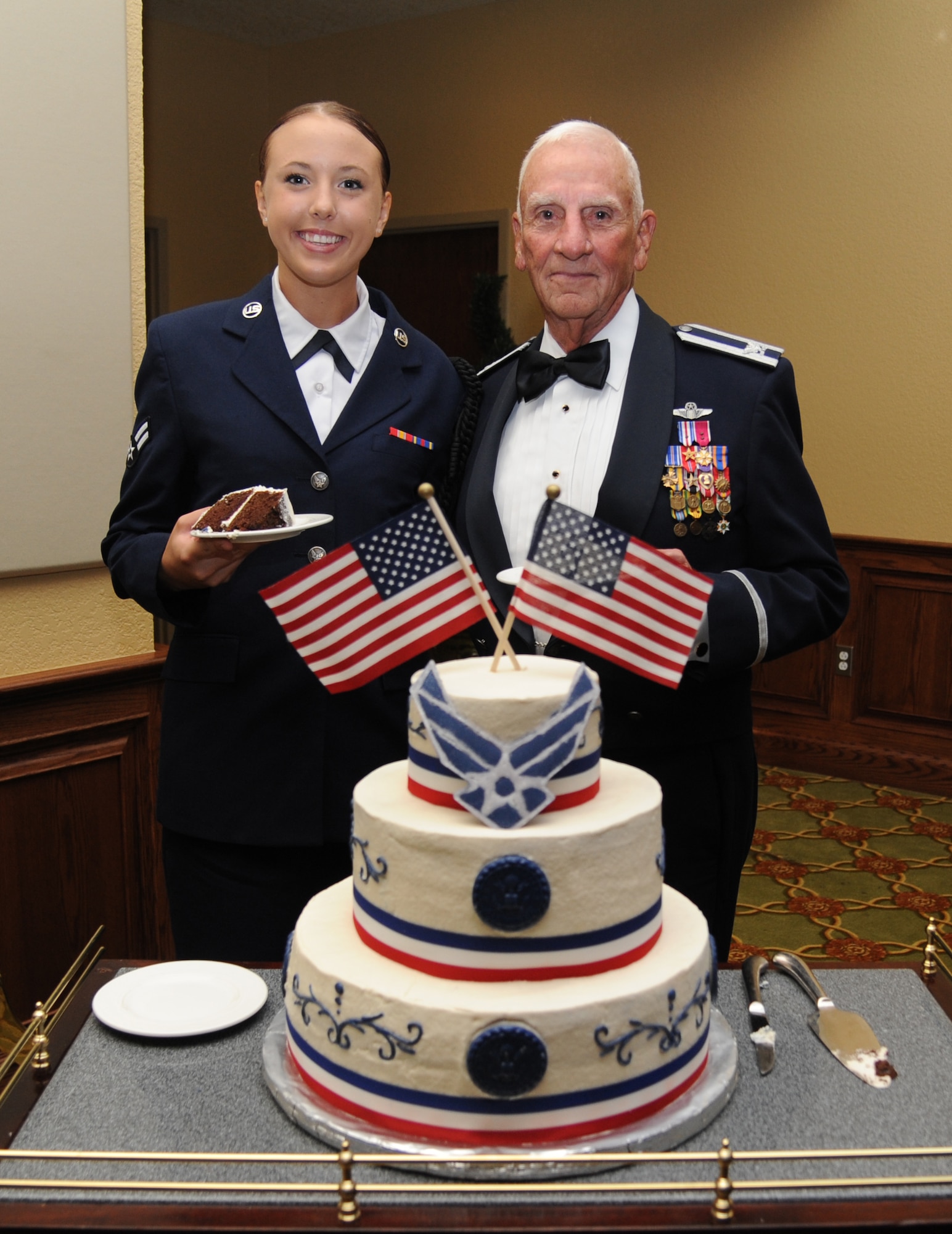 Airman 1st Class Kalynn Mitchell, 335th Training Squadron, and retired Col. Carlyle Harris, represent the youngest and oldest Airman in attendance for the cake cutting ceremony during the Air Force’s 66th Birthday Ball on Sept. 21, 2013, at Keesler Air Force Base, Miss. The event, sponsored by the Air Force Association, John C. Stennis Chapter #332, also celebrated the 81st Training Wing’s 20th anniversary.  (U.S. Air Force photo by Kemberly Groue)