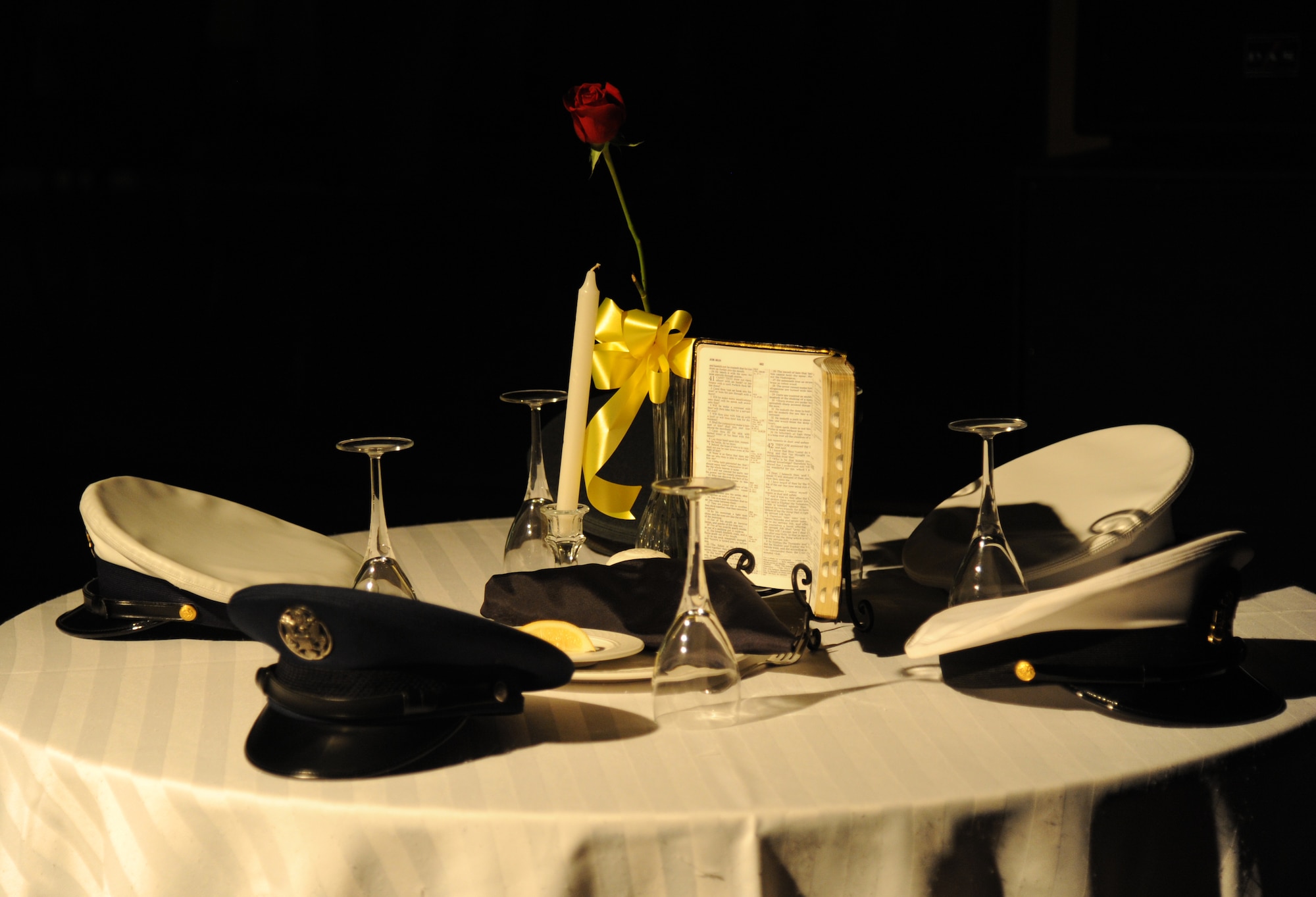A ceremonial prisoner of war/missing in action table sits under a spotlight during a tribute performance by the Keesler Honor Guard during the Air Force’s 66th Birthday Ball on Sept. 21, 2013, at Keesler Air Force Base, Miss. The event, sponsored by the Air Force Association, John C. Stennis Chapter #332, also celebrated the 81st Training Wing’s 20th anniversary.  (U.S. Air Force photo by Kemberly Groue)
