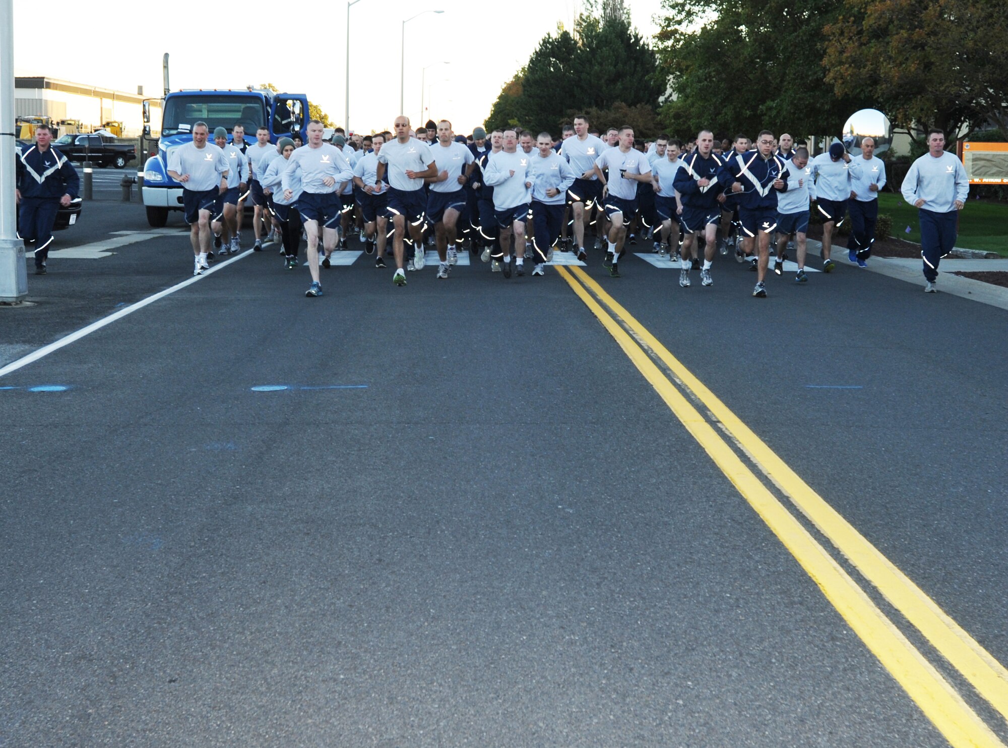 Members of Team Fairchild take off from the starting line during the wing run at Fairchild Air Force Base, Wash., Sept 20, 2013.  Fairchild Airmen participate in the group run monthly to increase physical fitness and enhance unit morale. (U.S. Air Force photo by Staff Sgt. Veronica Montes/Released)