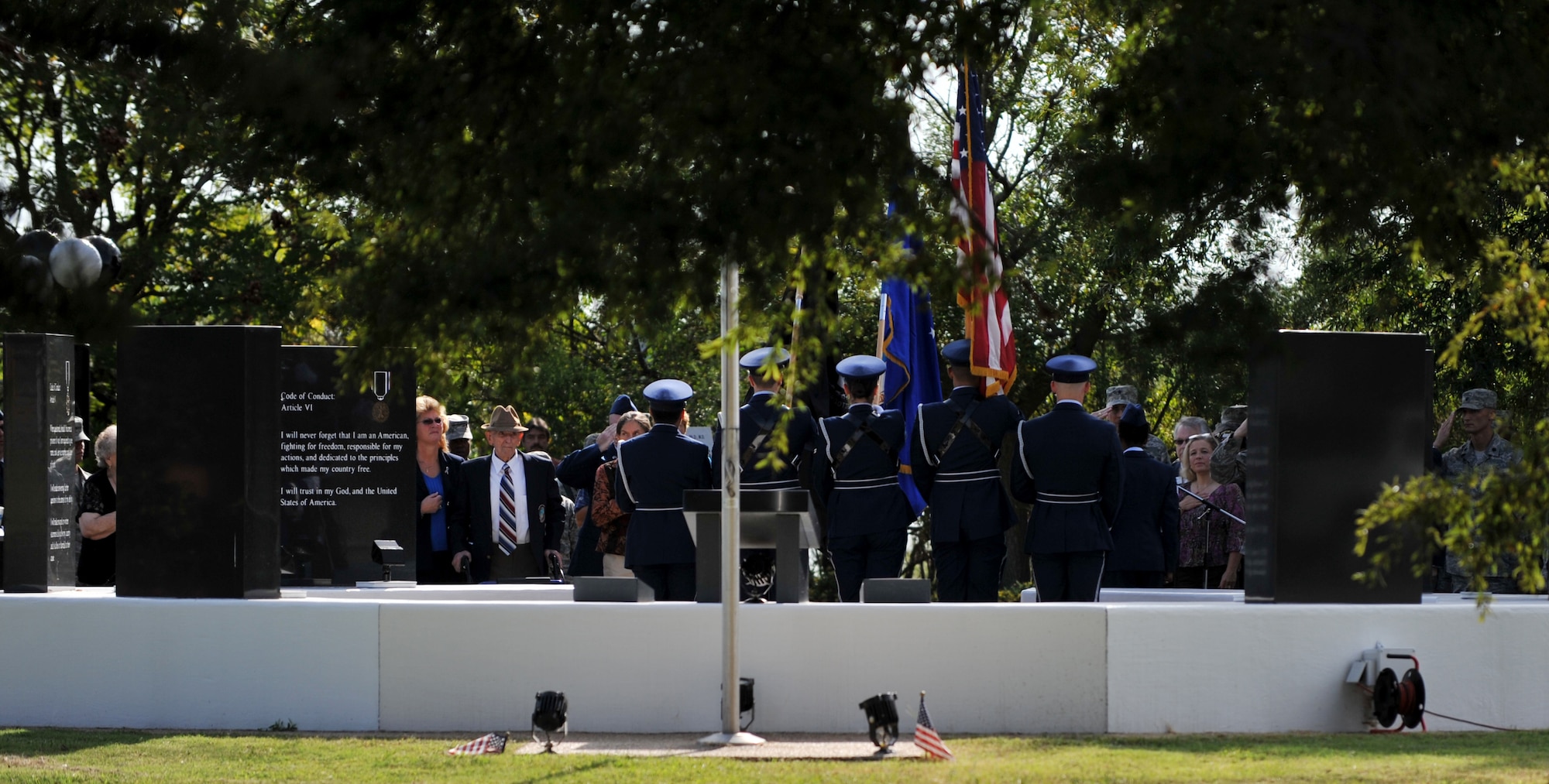 Attendees watch as the Langley Air Force Base Honor Guard posts the colors during the 2013 POW/MIA Recognition Day ceremony, Sept. 20, 2013. The ceremony honors POWs and MIAs across the nation. (U.S. Air Force photo by Staff Sgt. Jarad A. Denton/Released)