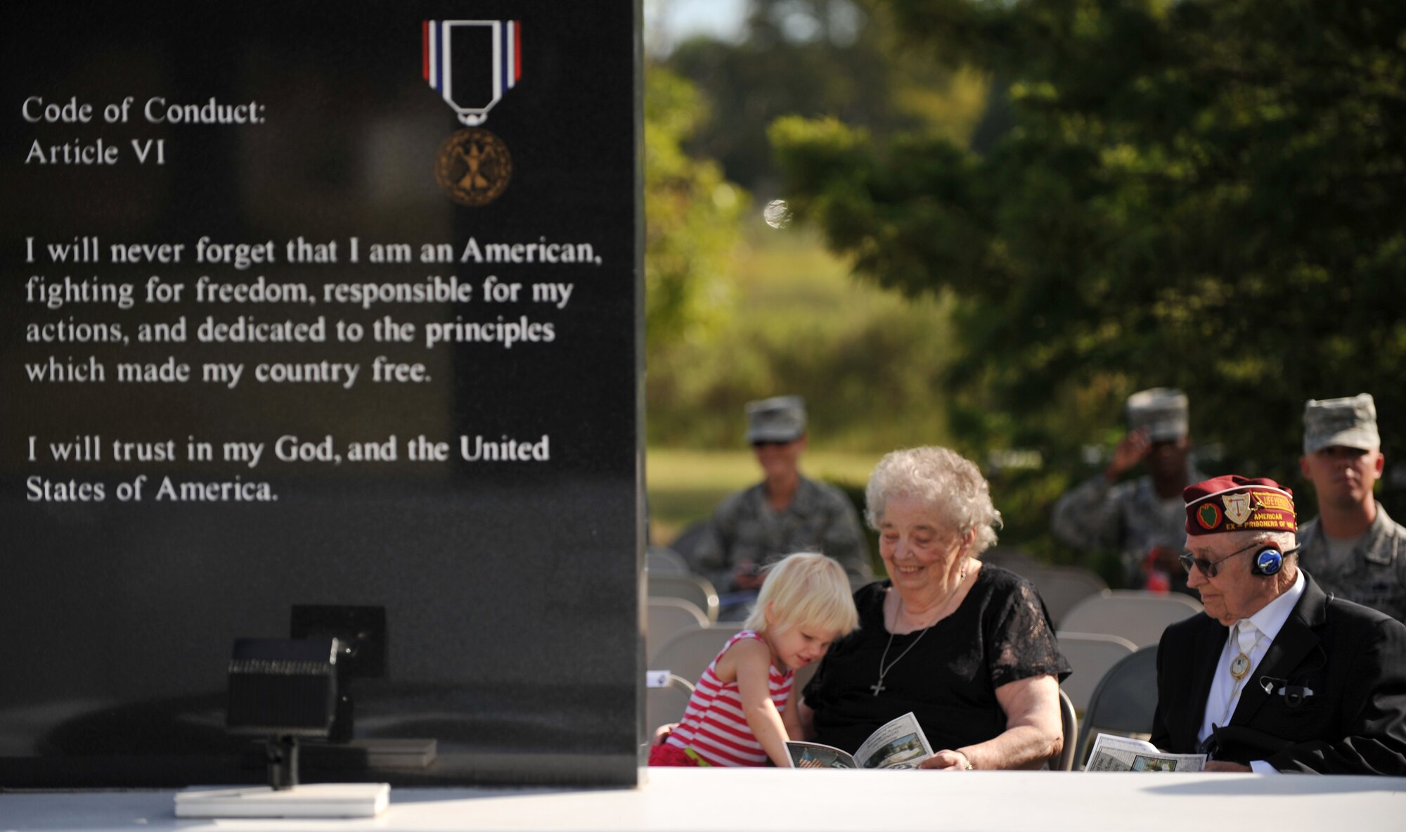 Retired U.S. Army Staff Sgt. Daniel Fenton, right, a Korean War veteran and former prisoner war, enjoys a moment with his family before the start of the 2013 POW/MIA Recognition Day ceremony at Langley Air Force Base, Va., Sept. 20, 2013. Although Fenton was eventually rescued, there are still more than 83,000 missing Service members unaccounted for since World War II. (U.S. Air Force photo by Staff Sgt. Jarad A. Denton/Released) 