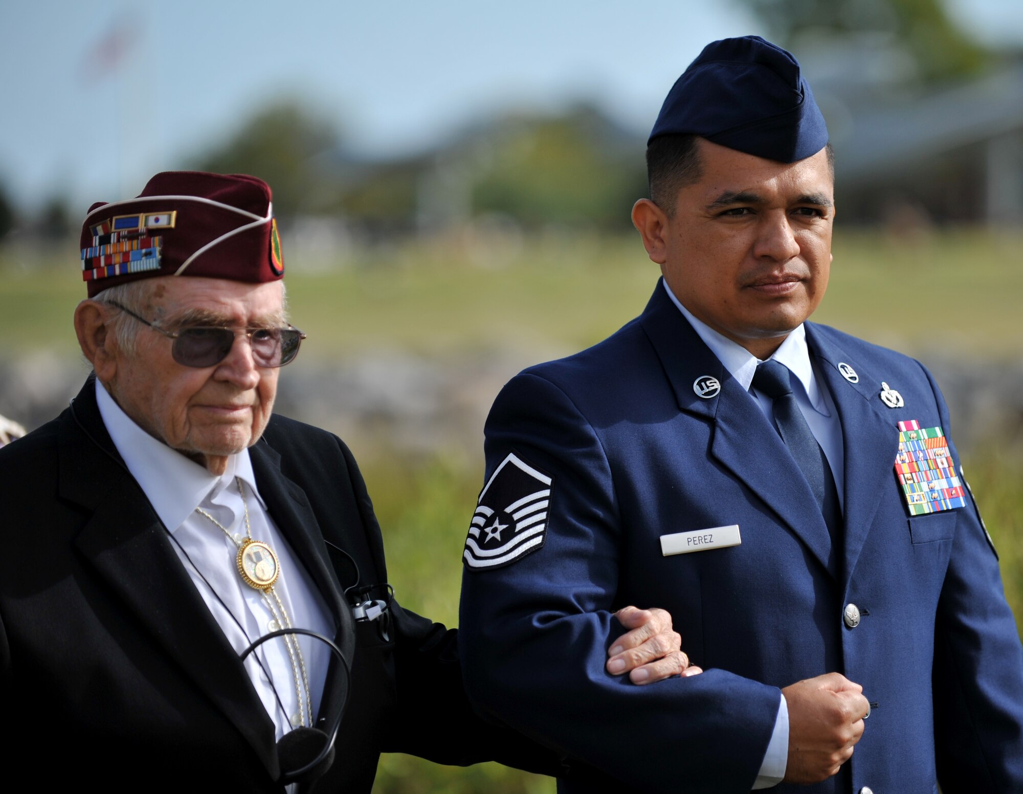 U.S. Air Force Master Sgt. Alfredo Perez, Air Combat Command A-7 civil engineering global force management superintendent, escorts retired U.S. Army Staff Sgt. Daniel Fenton, a Korean War veteran and former prisoner of war, to his seat at the 2013 POW/MIA Recognition Day ceremony on Langley Air Force Base, Va., Sept. 20, 2013. Fenton was captured April 25, 1951 and held for more than two years at Camp Changsong, Korea. (U.S. Air Force photo by Staff Sgt. Jarad A. Denton/Released) 