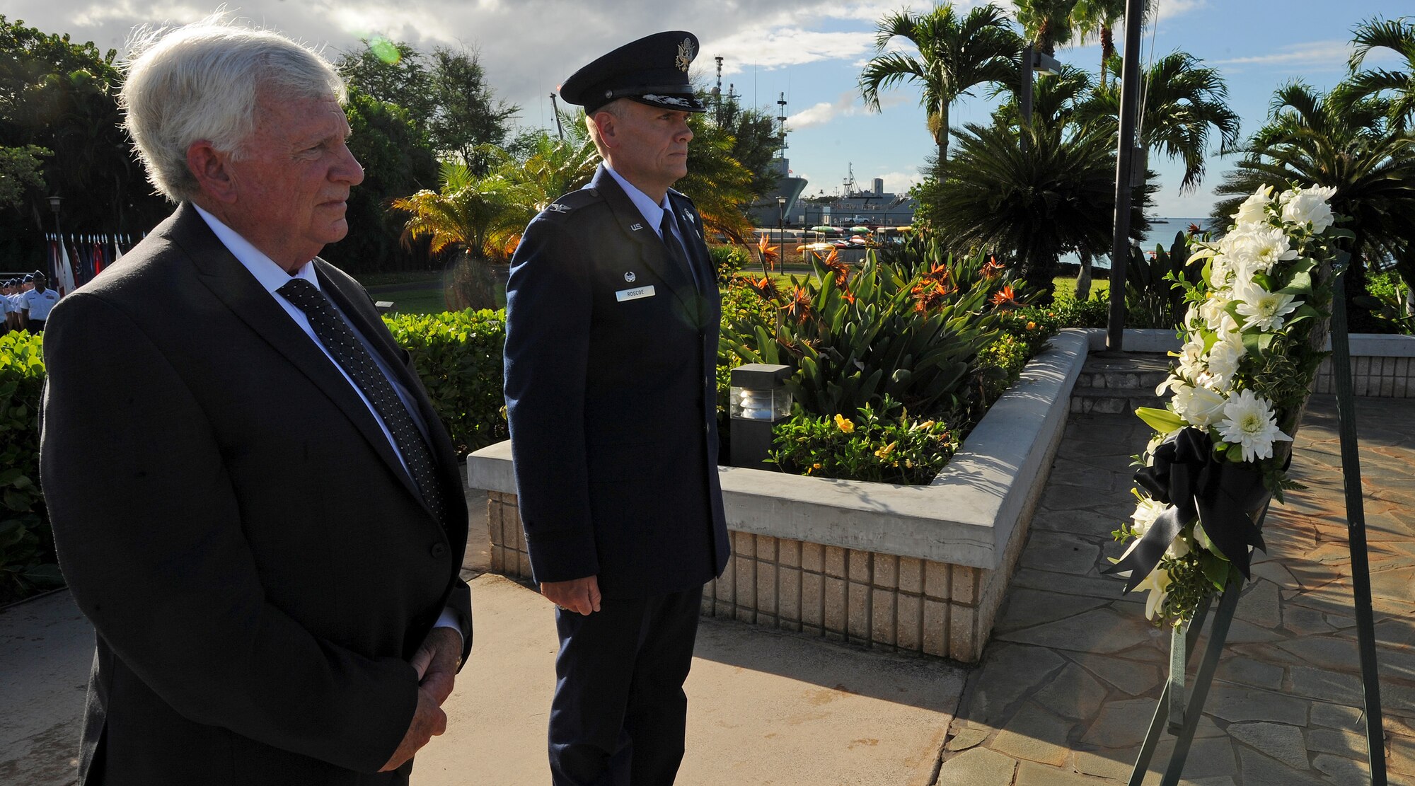 Former prisoner of war, retired Col. Henry Fowler, right, and Col. John Roscoe, 15th Wing commander, left  place a remembrance wreath at Missing Man Formation, Joint Base Pearl Harbor-Hickam, Hawaii, during the POW/MIA remembrance ceremony, Sept. 20, 2013. The gift of flowers at a memorial site is a ritual that occurs around the world, understood in every culture. The floral tributes at funerals bespeak both the beauty and the brevity of life and evoke memories of other days. (U.S. Air Force photo/Tech. Sgt. Jerome S. Tayborn)