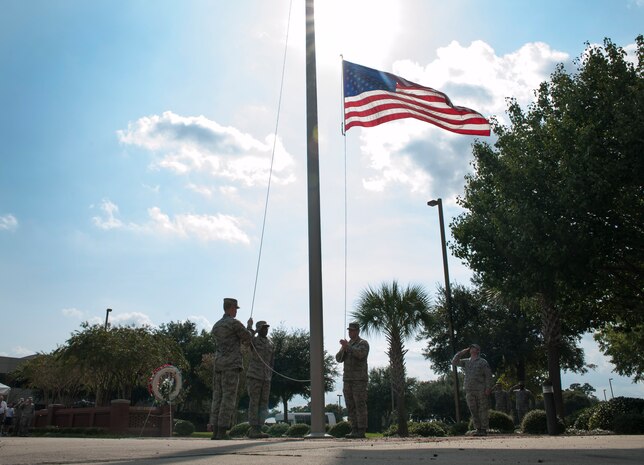 Airman 1st Class Matthew Lewis and Senior Airman Tyler Vaughn, Joint Base Charleston Honor Guardsmen, retire the colors during the Prisoner of War/Missing in Action retreat ceremony Sept. 23, 2013, at JB Charleston – Air Base, S.C. The ceremony included a 21-gun salute by the Honor Guard, a wreath-laying and bagpipe music in recognition of captured, killed-in-action and missing U.S. servicemembers. (U.S. Air Force photo/Senior Airman Ashlee Galloway)