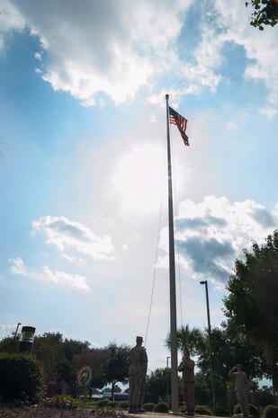 Airman 1st Class Matthew Lewis and Senior Airman Tyler Vaughn, JB Charleston Honor Guardsmen, retire the colors during the Prisoner of War/Missing in Action retreat ceremony Sept. 23, 2013 at Joint Base Charleston – Air Base, S.C. The ceremony included a 21-gun salute by the Honor Guard, a wreath-laying and bagpipe music in recognition of captured, killed-in-action and missing U.S. servicemembers. (U.S. Air Force photo/Senior Airman Ashlee Galloway)