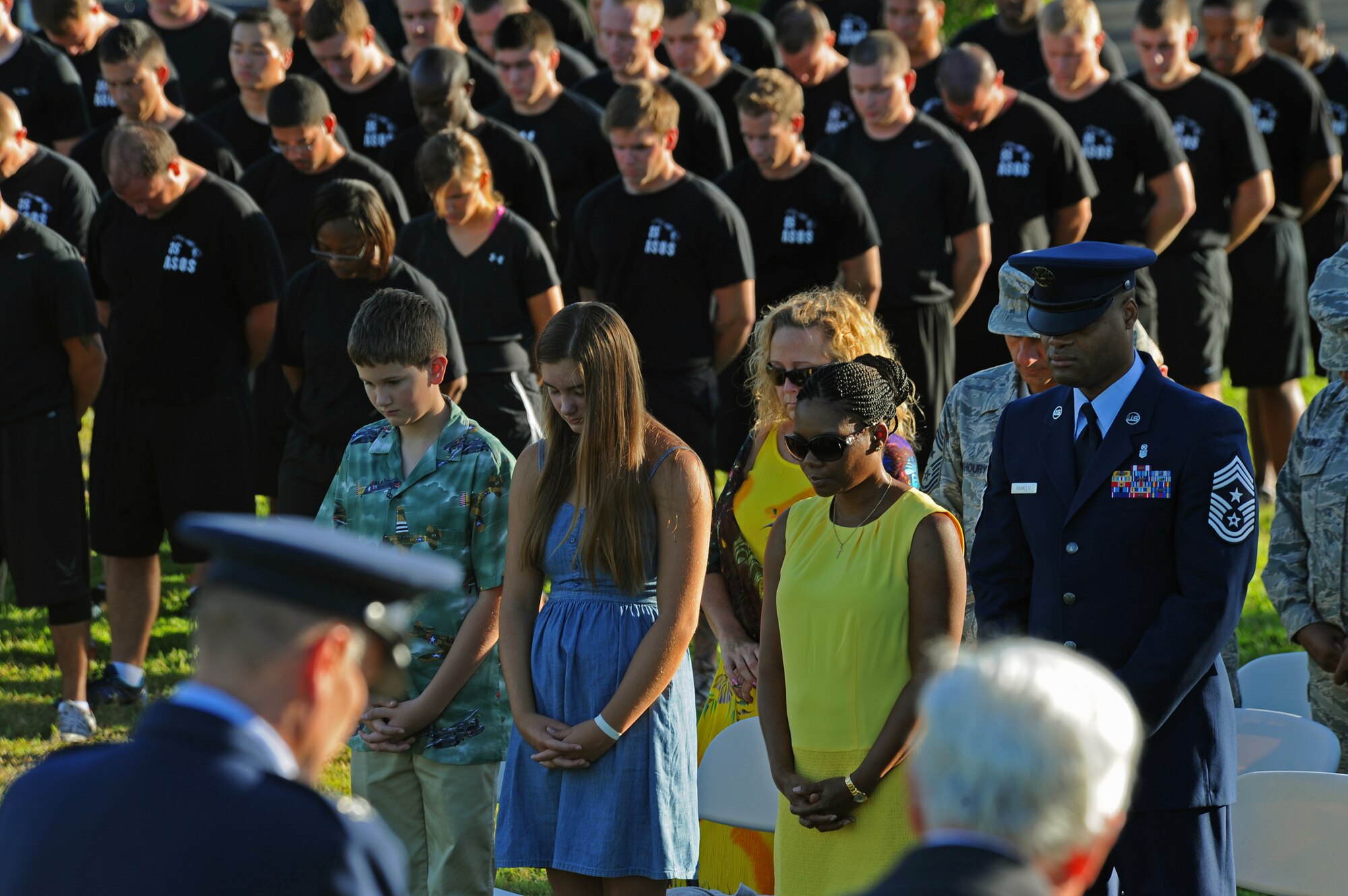 15th Wing personnel, 25th Air Support Operations Squadron, and guests bow their heads in respect  and listen to the invocation during the prisoners of war/missing in action remembrance ceremony at Missing Man Formation, Joint Base Pearl Harbor-Hickam, Hawaii, Sept. 20, 2013. More than 300 Airmen/Sailors and guest attended the somber event. (U.S. Air Force photo/Tech. Sgt. Jerome S. Tayborn)