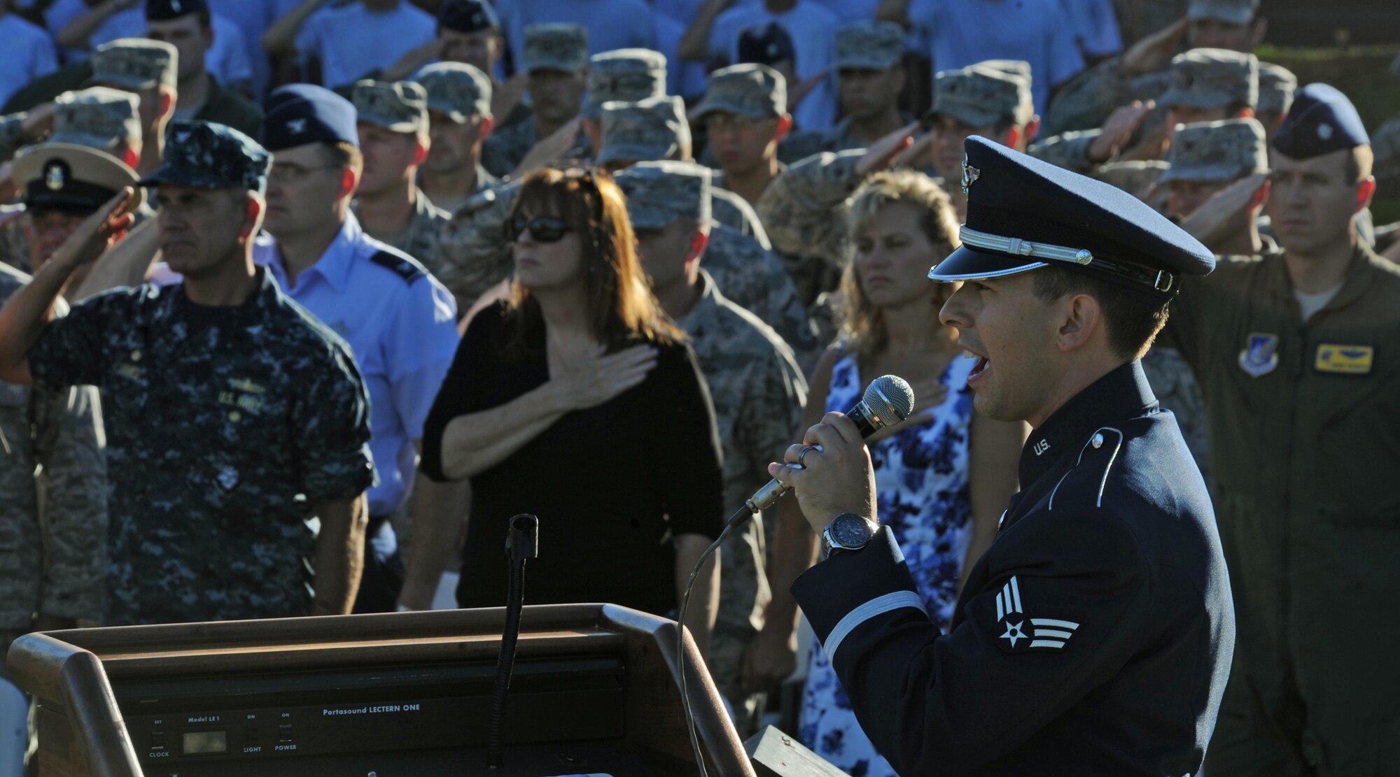 Senior Airman Devin Rivas Martin, vocalist from the Pacific Air Forces Band of the Pacific, sings the national anthem during the POW/MIA remembrance ceremony at Missing Man Formation, Joint Base Pearl Harbor-Hickam, Hawaii, Sept. 20, 2013. (U.S. Air Force photo/Tech. Sgt. Jerome S. Tayborn)