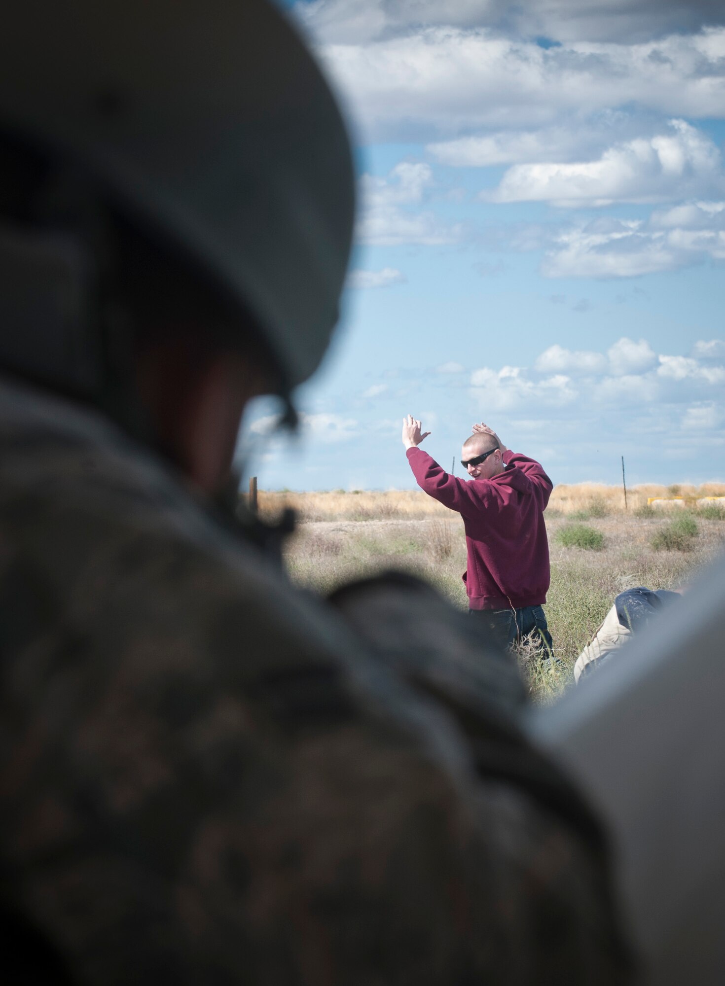 A U.S. Air Force Airman from the 726th Air Control Squadron shouts to direct a simulated foreigner during an exercise Sept. 18, 2013, at Mountain Home Air Force Base, Idaho. To prepare for deployments, 726th ACS Airmen must go through expeditionary combat skills training to equip them with the tools to successfully carry out their mission. Knowing how to properly, and legally, detain a foreigner is crucial to base security and to prevent enemy forces from infiltrating their position. (U.S. Air Force photo by Airman 1st Class Brittany A. Chase/Released)