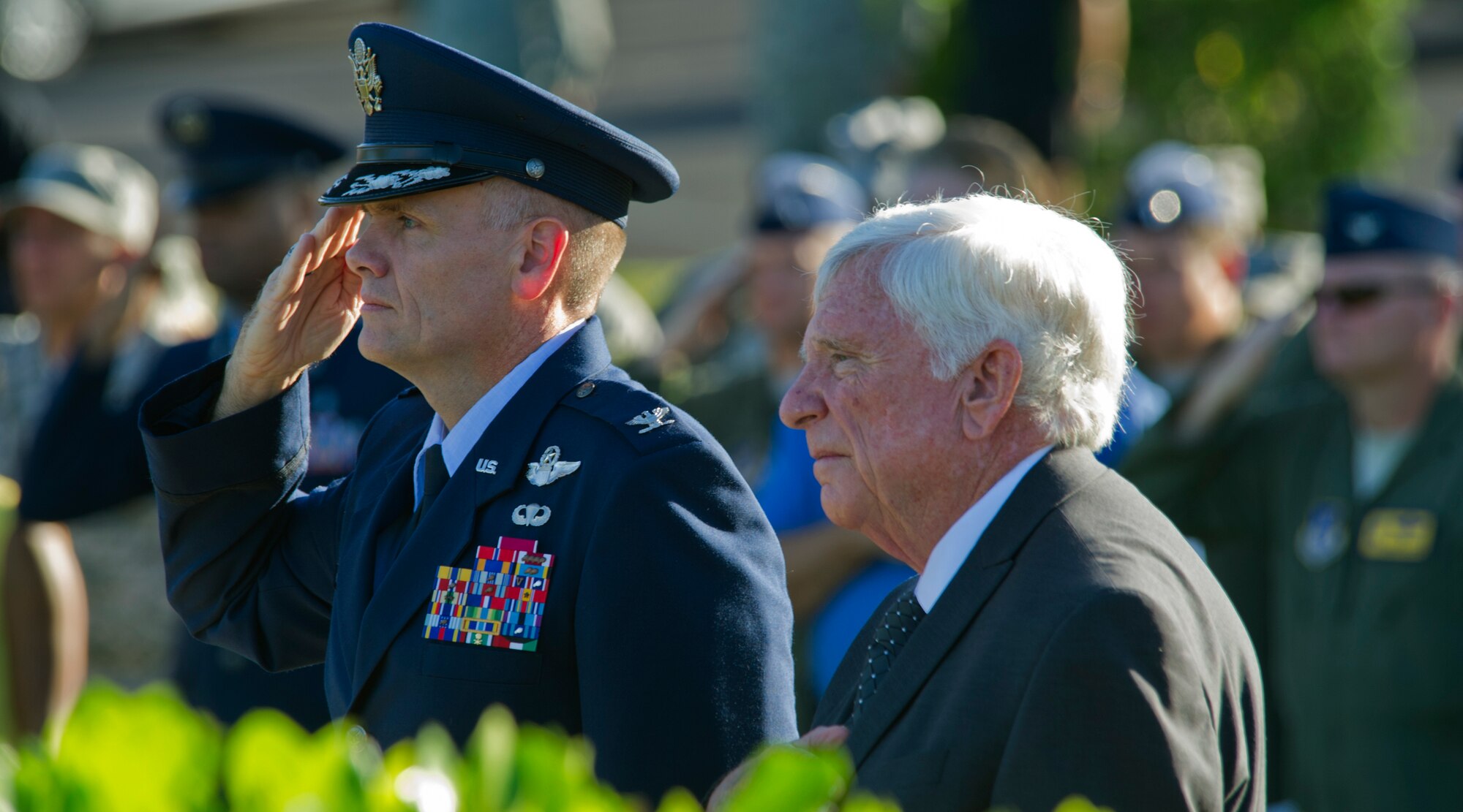 Col. John Roscoe, 15th Wing commander and former prisoner of war, retired Col. Henry Fowler pay respect to the raising of the U.S. flag and the prisoners of war/missing in action flag during the POW/MIA remembrance ceremony at Missing Man Formation, Joint Base Pearl Harbor-Hickam, Hawaii, Sept. 20, 2013. The United States’ National POW/MIA Recognition Day is observed across the nation on the third Friday of September each year. Many Americans take the time to remember those who were prisoners of war (POW) and those who are missing in action (MIA), as well as their families. (U.S. Air Force photo/Tech. Sgt. Jerome S. Tayborn)