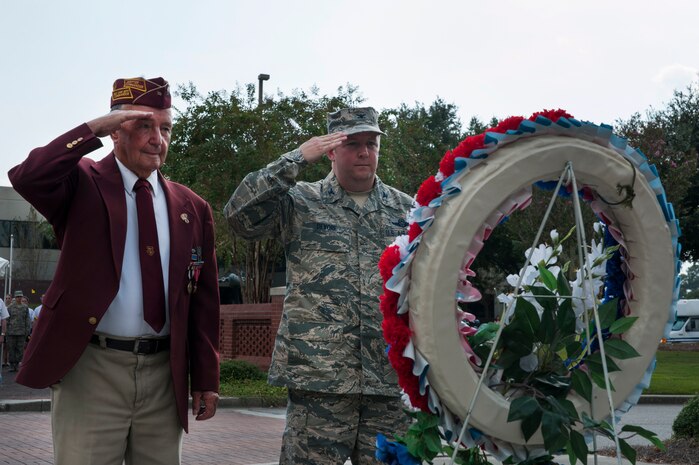 Reggie Salisbury, a U.S. Army infantry veteran, D-Day survivor and World War II prisoner of war, and Col. Jeff DeVore, Joint Base Charleston commander, salute after laying a wreath during the Prisoner of War/Missing in Action retreat ceremony Sept. 23, 2013, at JB Charleston – Air Base, S.C.  (U.S. Air Force photo/Senior Airman Ashlee Galloway)