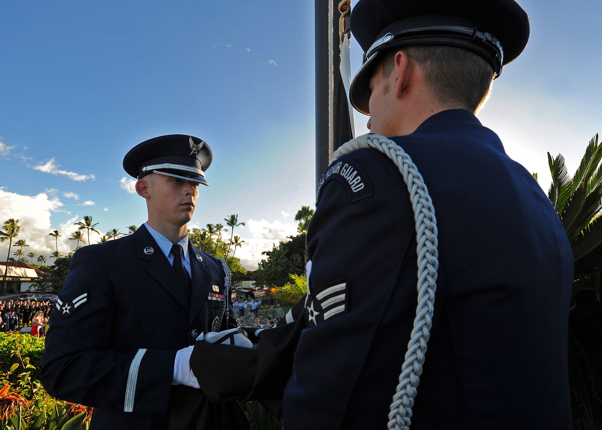 Members of the Joint Base Pearl Harbor-Hickam Honor Guard team Airman 1st Class Travis Brooks, and Senior Airman Jacob Stowe prepare to raise the prisoner of war/missing in action flag, during the POW/MIA remembrance ceremony at Missing Man Formation, Joint Base Pearl Harbor-Hickam, Hawaii, Sept. 20, 2013.  The 15th wing wrapped up a week-long tribute to those held as POW/MIA.  (U.S. Air Force photo/Tech. Sgt. Jerome S. Tayborn)