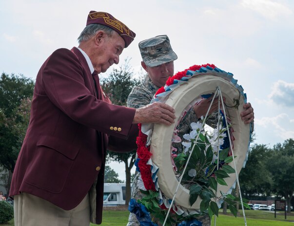 Reggie Salisbury, U.S. Army infantry veteran, D-Day survivor and World War II prisoner of war, and Col. Jeff DeVore, Joint Base Charleston commander, lay a wreath during the Prisoner of War/Missing in Action retreat ceremony Sept. 23, 2013, at JB Charleston – Air Base, S.C. (U.S. Air Force photo/Senior Airman Ashlee Galloway