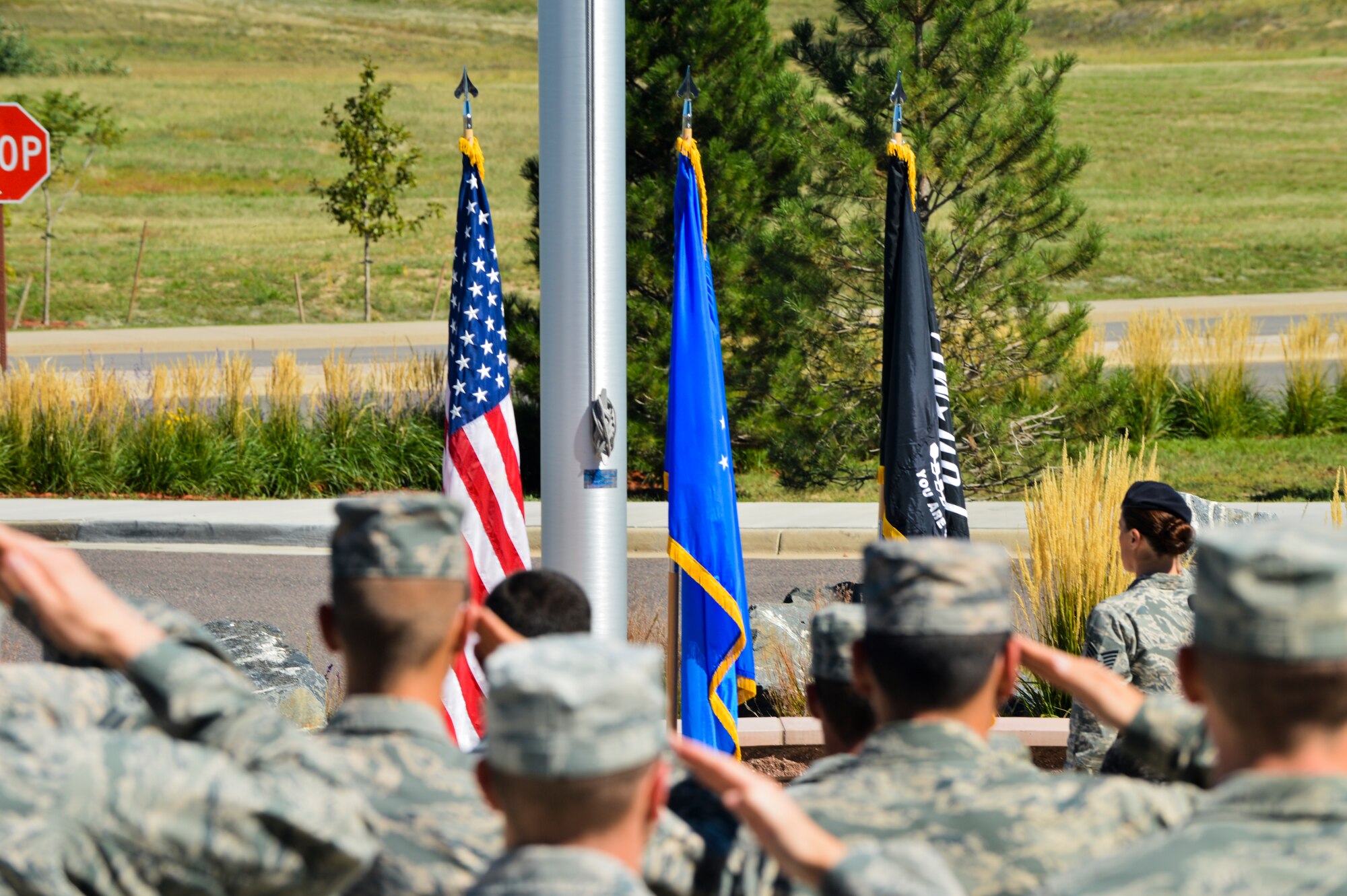Team Buckley service members salute the American flag during the National POW/MIA Recognition Day ceremony Sept. 20, 2013, at the 460th Space Wing headquarters building on Buckley Air Force Base, Colo. National POW/MIA Recognition Day is traditionally observed the third Friday of September. (U.S. Air Force photo by Staff Sgt. Paul Labbe/Released)