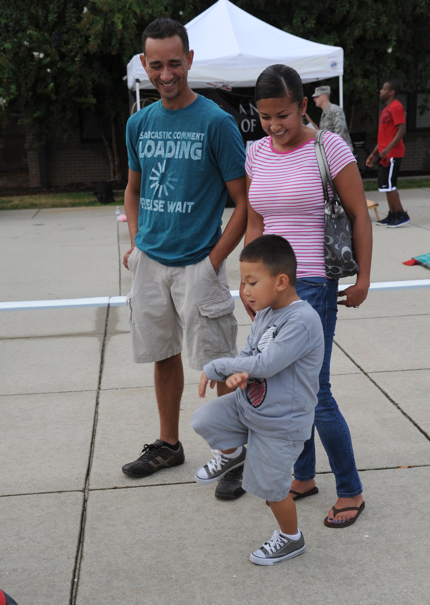 Tech. Sgt. Triscia Garcia, 334th Training Squadron, and her husband watch their son dance during the Air Force’s 66th birthday celebration Sept. 20, 2013, Keesler Air Force Base, Miss. The event also included a cake cutting ceremony, music, games, contests and food. Hill won the hula hoop competition.  (U.S. Air Force photo by Kemberly Groue)