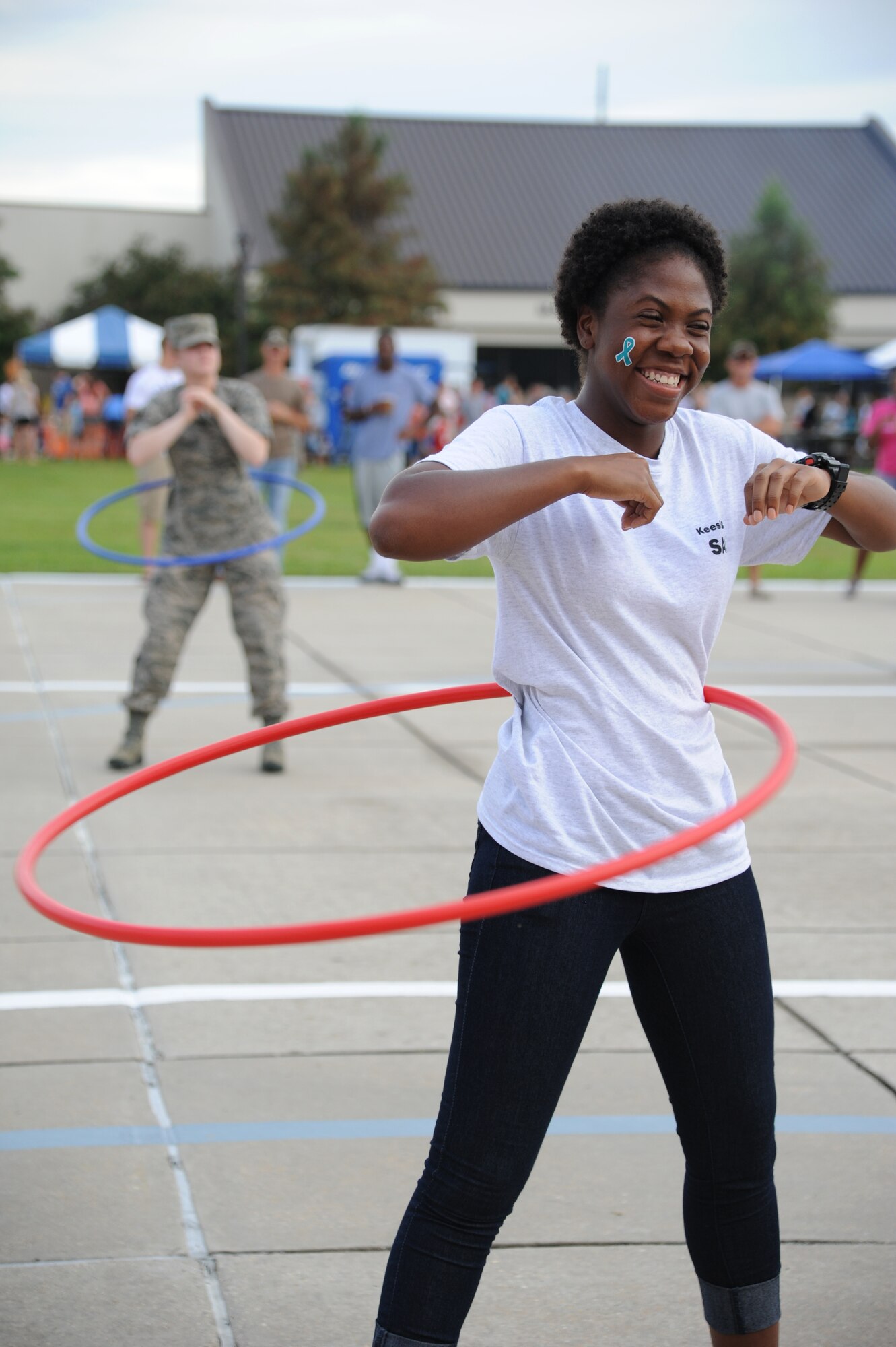 Airman Basic Shamiya Hill, 336th Training Squadron, participate in a hula hoop competition during the Air Force’s 66th birthday celebration Sept. 20, 2013, Keesler Air Force Base, Miss. The event also included a cake cutting ceremony, music, games, contests and food.  Hill won the hula hoop competition.  (U.S. Air Force photo by Kemberly Groue)