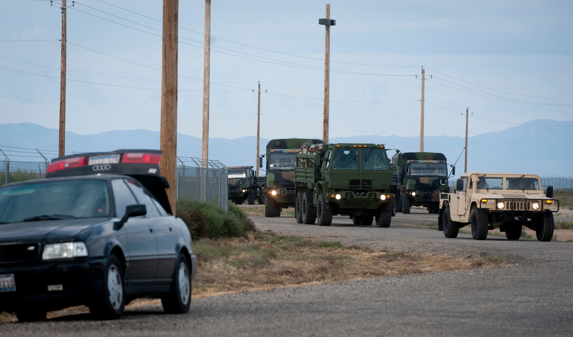 U.S. Air Force Airmen from the 726th Air Control Squadron ride in vehicles during a convoy to the mobile operating air base Sept. 17, 2013, at Mountain Home Air Force Base, Idaho. Convoy practice trains Airmen to be aware of their surroundings when safely moving from point to point. During the convoys, teams encounter many scenarios such as a vehicle born improvised explosive device. (U.S. Air Force photo by Airman 1st Class Brittany A. Chase/Released)