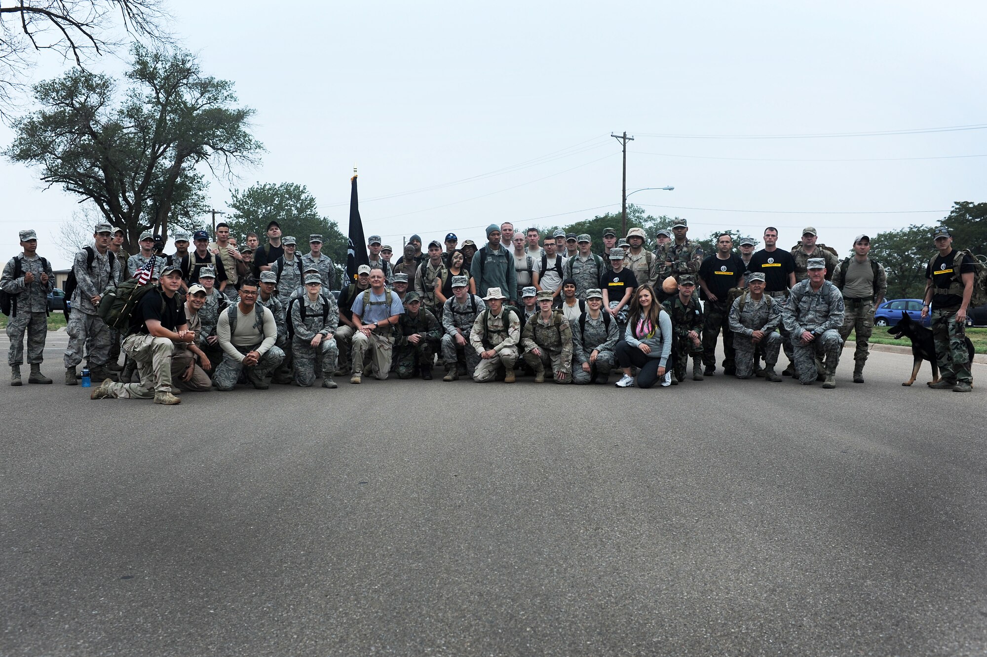 Members of the 27th Special Operations Wing pose for a group photo after participating in a ruck march to kick-off Prisoner of War/Missing in action week Sept. 16, 2013 at Cannon Air Force Base, N.M. Those who attended the ruck march took time to remember the POW/MIA personnel.