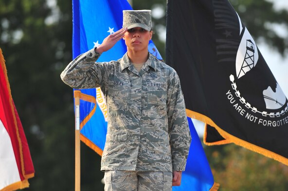 U.S. Air Force Senior Airman Amber Coley, 4th Medical Operations Squadron physical therapy technician, renders a salute as the U.S. military Code of Conduct is recited during the 4th Fighter Wing Prisoner of War/Missing in Action (POW/MIA) ceremony at Seymour Johnson Air Force Base, N.C., Sept. 20, 2013. The Code of Conduct, in six articles, addresses basic information useful to POWs when captured by hostile forces. (U.S. Air Force photo by Senior Airman Aubrey White)