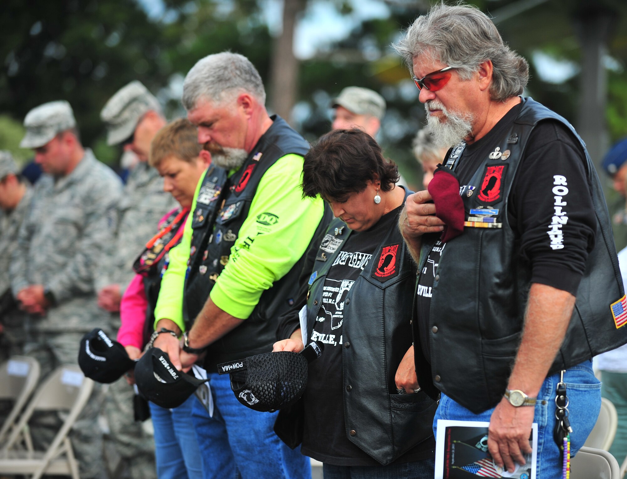 Members of Rolling Thunder North Carolina Chapter 7, a non-profit organization committed to helping veterans, bow their heads during the 4th Fighter Wing Prisoner of War/Missing in Action (POW/MIA) ceremony at Seymour Johnson Air Force Base, N.C., Sept. 20, 2013. The ceremony commemorated the lives of POWs and MIAs, both accounted and unaccounted for, since WWII. (U.S. Air Force photo by Senior Airman Aubrey White)