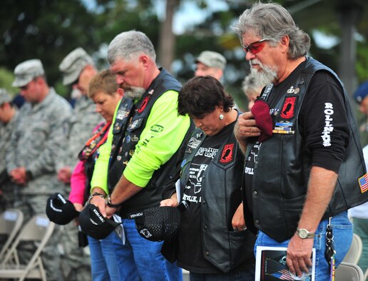 Members of Rolling Thunder North Carolina Chapter 7, a non-profit organization committed to helping veterans, bow their heads during the 4th Fighter Wing Prisoner of War/Missing in Action (POW/MIA) ceremony at Seymour Johnson Air Force Base, N.C., Sept. 20, 2013. The ceremony commemorated the lives of POWs and MIAs, both accounted and unaccounted for, since WWII. (U.S. Air Force photo by Senior Airman Aubrey White)