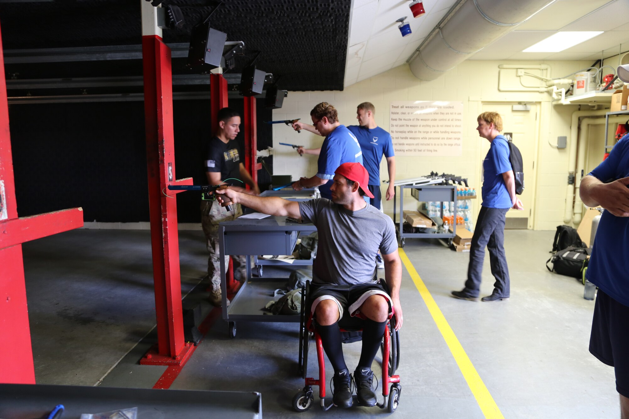 Army Capt. Edward Gunderson (left), Air Force Wounded Warrior Program Adaptive Sports Camp coach, teaches wounded warriors how to shoot pellet guns at the Joint Base San Antonio-Randolph shooting range Sept. 18. (U.S. Air Force photo by Rich McFadden/released)