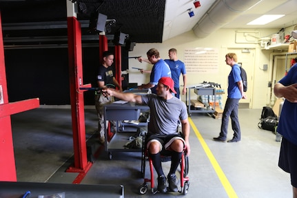 Army Capt. Edward Gunderson (left), Air Force Wounded Warrior Program Adaptive Sports Camp coach, teaches wounded warriors how to shoot pellet guns at the Joint Base San Antonio-Randolph shooting range Sept. 18. (U.S. Air Force photo by Rich McFadden/released)