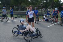 Troy Foster, Air Force Wounded Warrior Program Adaptive Sports Camp coordinator, discusses the cycling route with retired Staff Sgt. Megan Lyon Sept. 18 at Joint Base San Antonio-Randolph. The camp was provided by the Air Force Wounded Warrior Program, which introduces wounded, injured and ill Airmen to adaptive sports, such as wheelchair basketball and sitting volleyball, as early in the healing process as possible to get them interested in competing locally, or even at the national level at the Warrior Games in Colorado Springs, Colo. (U.S. Air Force photo by Joel Martinez/Released)
