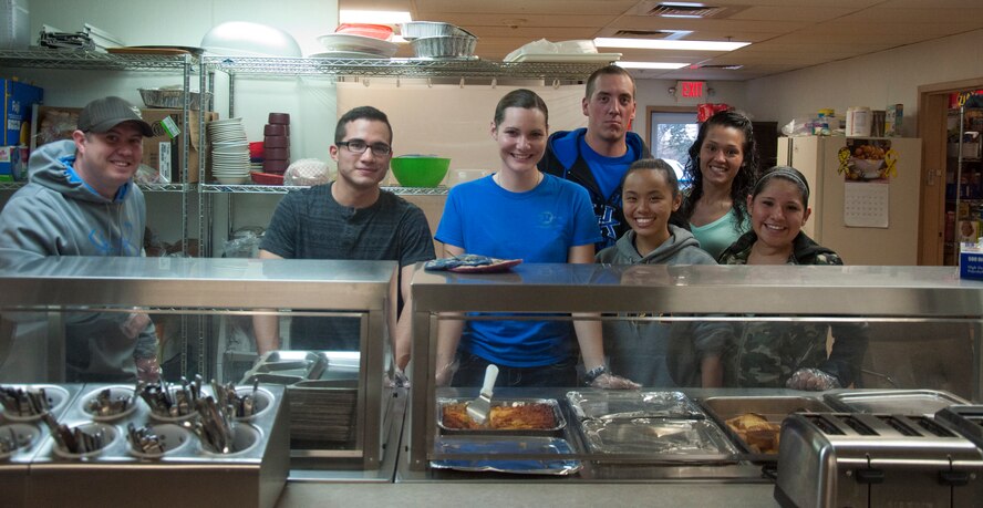 A group of eight Airmen traveled to the Comea House Homeless Shelter, Cheyenne, Wyo., to serve dinner to the homeless Sept. 18, 2013. The group consisted of Chaplain (Capt.) Robert Tilley, 90th Missile Wing Chaplain Office chaplain; Airman 1st Class Brandon Valle, 90th MW Public Affairs; Airman 1st Class Kimberly Perez, 90th Security Forces Squadron; Senior Airman Jameson McBride, Airmen 1st Class Tatyana Gonzalez and Mattie Decker, and Airmen Sixto Garcia and Angela Lee, all with the 790th Missile Security Forces Squadron. (US Air Force photo by Airman 1st Class Brandon Valle)