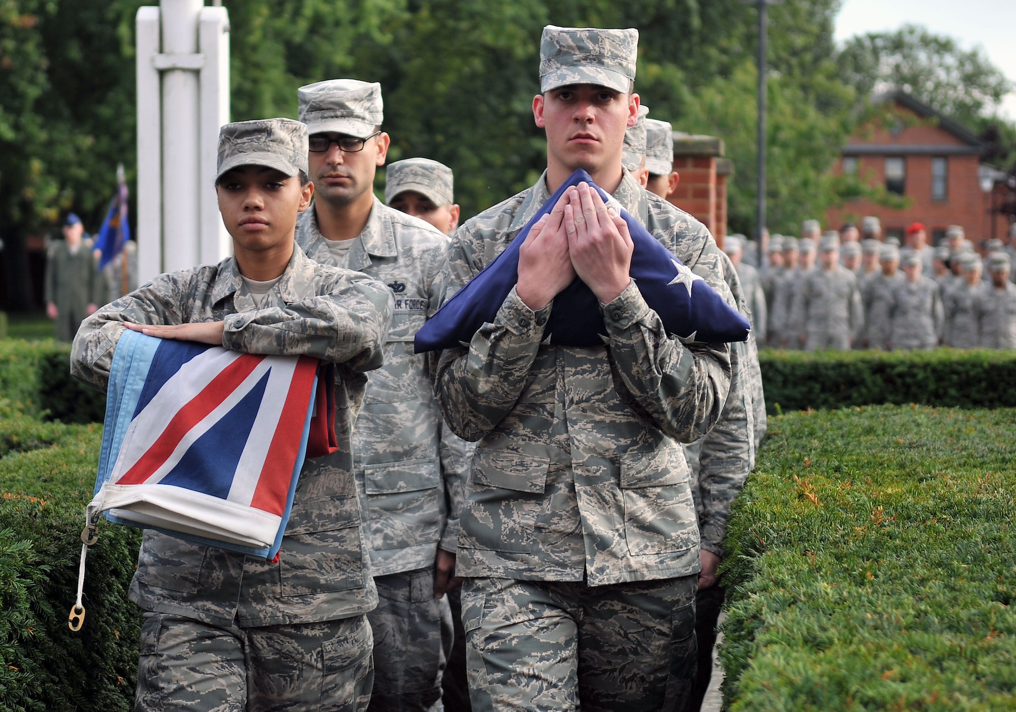 Members of the Team Mildenhall Honor Guard march during a retreat ceremony Sept. 20, 2013, on RAF Mildenhall, England. RAF Mildenhall held a ceremonial retreat in honor of the service members held prisoners of war or missing in action. Retreat is a long-standing tradition honoring the flag and signaling the end of the duty day. (U.S. Air Force photo by Airman 1st Class Kyla Gifford/Released)