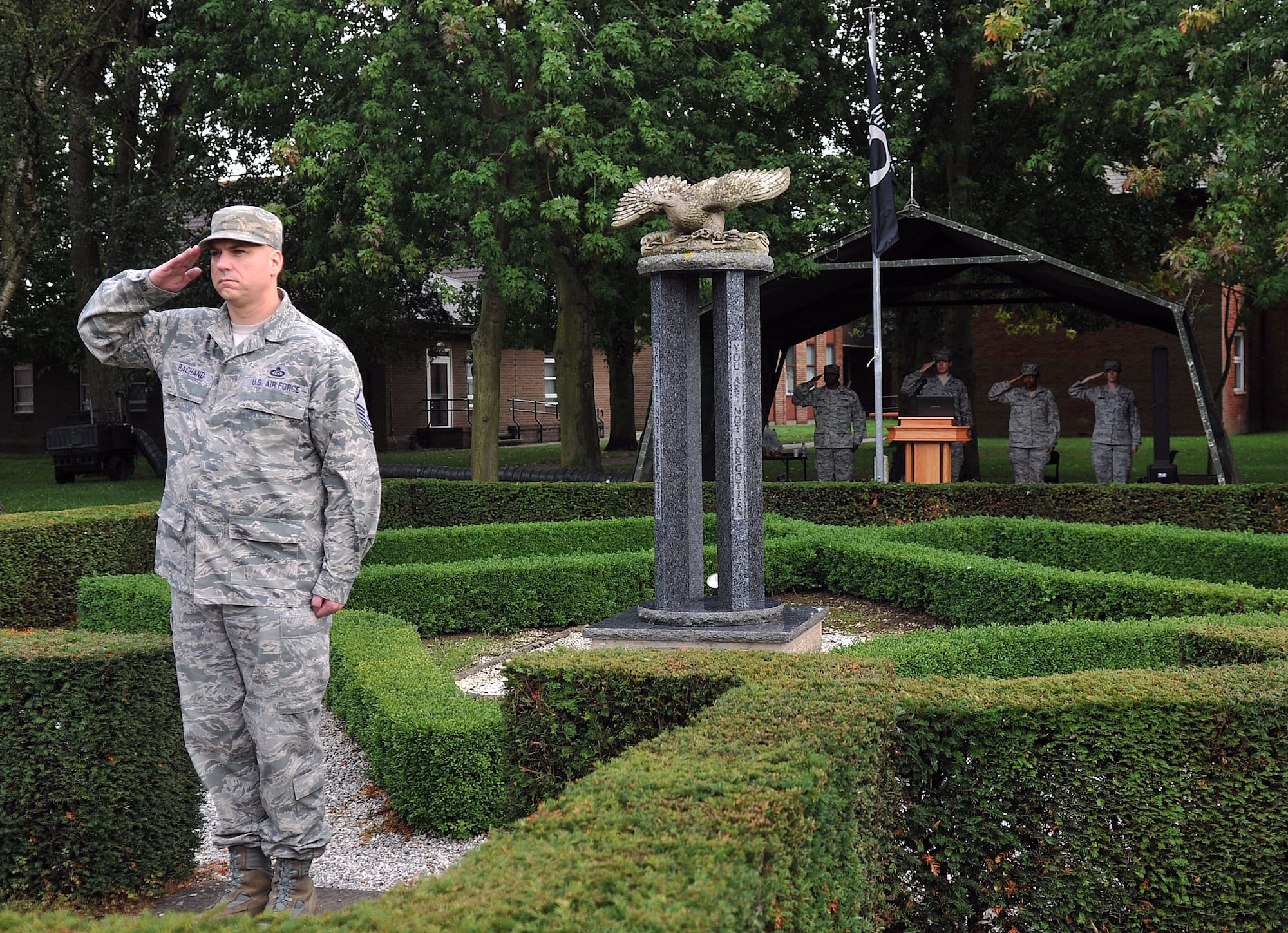 Team Mildenhall members salute the U.S. flag and Royal Air Force ensign during a retreat ceremony Sept. 20, 2013, on RAF Mildenhall, England. There are more than 83,000 U.S. service members missing in action from World War II, the Korean War, the Cold War, the Vietnam War, Iraq and other conflicts. In remembrance of these individuals and prisoners of war, RAF Mildenhall held a ceremonial retreat. (U.S. Air Force photo by Airman 1st Class Kyla Gifford/Released)