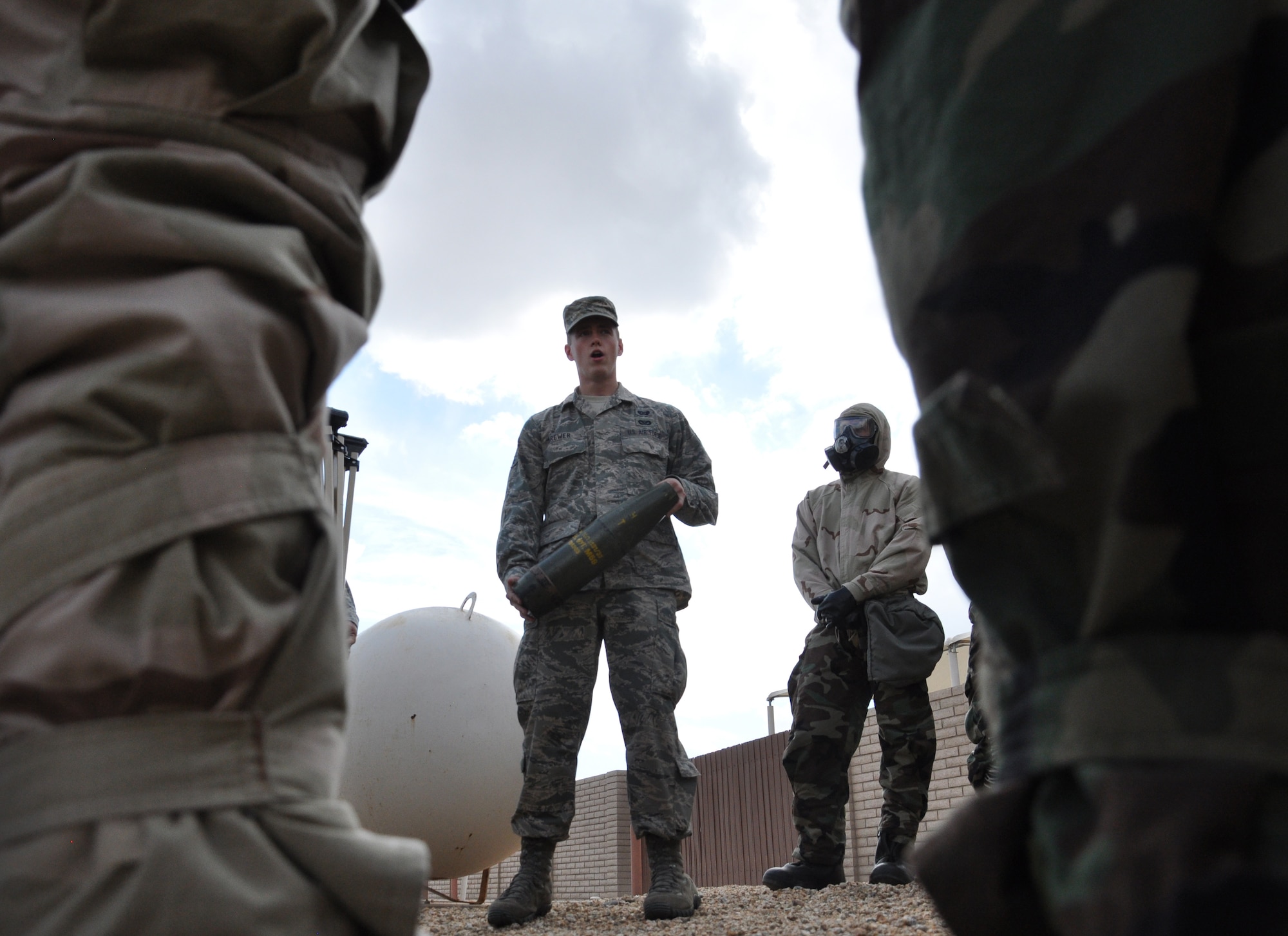 Airmen 1st Class Jacob Brewer, 56th Civil Engineer Squadron Readiness and Emergency Management apprentice, examines unexploded ordnance Sept. 10 at the 56th CES REM Flight building. Airmen receive chemical, biological, radiological, nuclear and explosive defense survival skill training prior to deploying. (U.S. Air Force photo/Staff Sgt. Luther Mitchell)