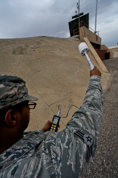 Using an isotropic electric field probe, Senior Airman Christopher Odom, 56th AMDS BEE technician, tests the electromagnetic frequency coming from the radar at the north end of the runway. The test helps determine the safe zone around equipment. (U.S. Air Force photo/Staff Sgt. C.J. Hatch)