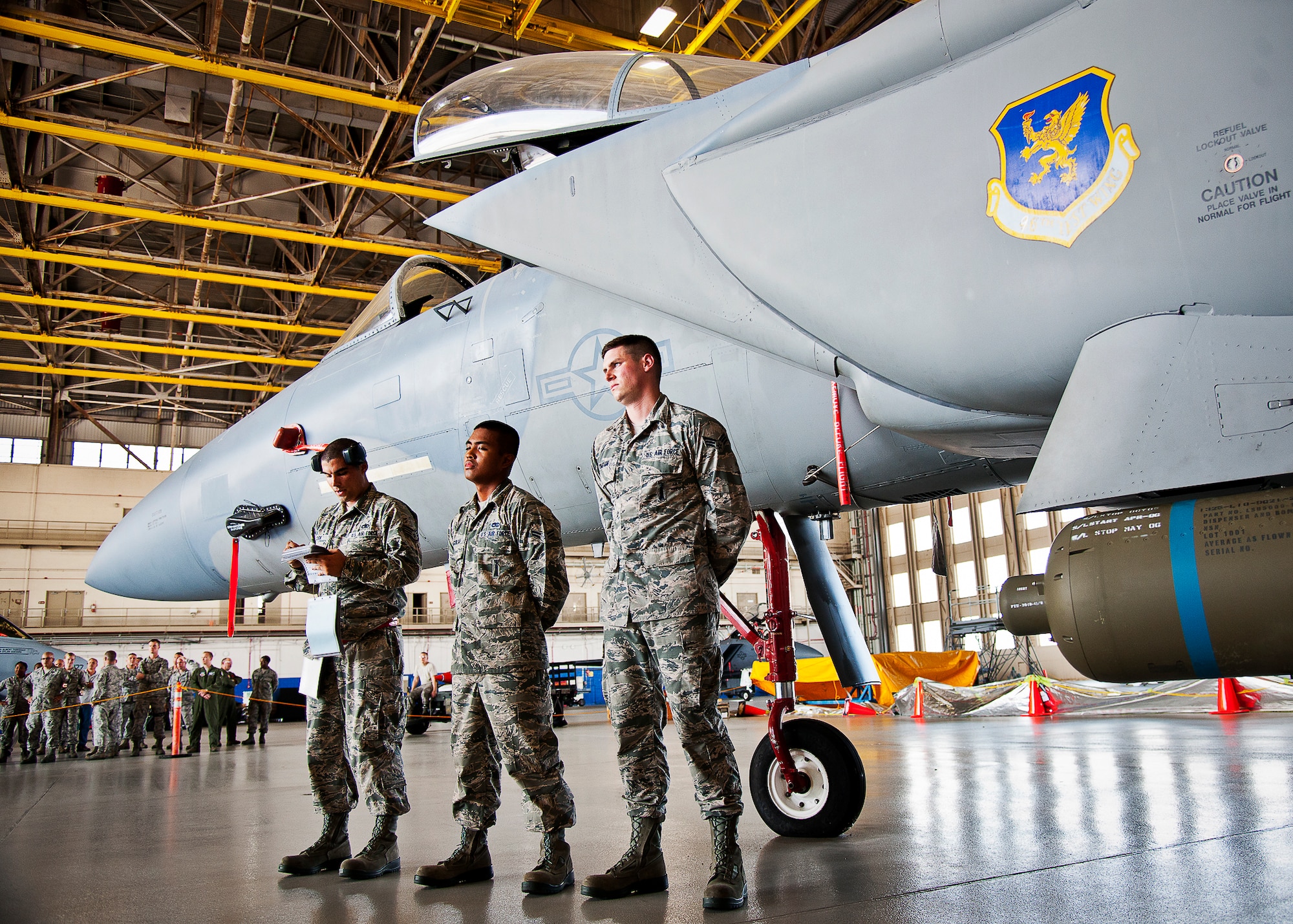 The 96th Aircraft Maintenance Squadron Red Team of Staff Sgt. Derek Cook, Airman 1st Class Marqwilliam Aguilar and Senior Airman Mark Timpani line up to report they’ve completed the weapons load during the 96th Maintenance Group’s quarterly weapons loadcrew competition Sept. 20 at Eglin Air Force Base, Fla.  The Red Team defeated AMU Blue in the competition. (U.S. Air Force photo/Samuel King Jr.)