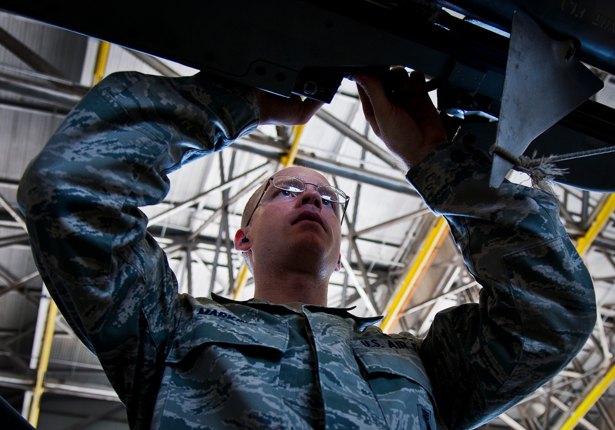Senior Airman Tyler Marking of the 96th Aircraft Maintenance Squadron Blue, checks the connections on an AIM-9 to his F-16 during the 96th Maintenance Group’s quarterly weapons loadcrew competition Sept. 20 at Eglin Air Force Base, Fla. Staff Sgt. Seth Ellerbee, Marking and Airman 1st Class Andrew Jensen represented the Blue AMU.  AMU Red won the competition. (U.S. Air Force photo/Samuel King Jr.)